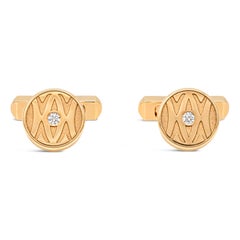 Gemelos Cartier firmados con diamante redondo de 0,14 quilates en oro amarillo cepillado de 18 quilates