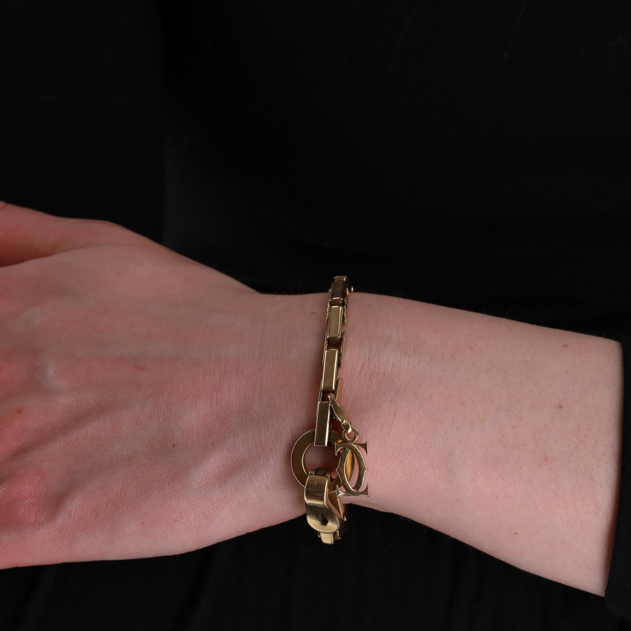 Cartier 18k Gold Agrafe Bracelet With Cartier Logo Charm
From Cartier's signature Agrafe collection is this flat link bracelet with clasp motif crafted from 18k gold.

Featuring iconic Agrafe closure and removable two intertwined Cs Cartier logo