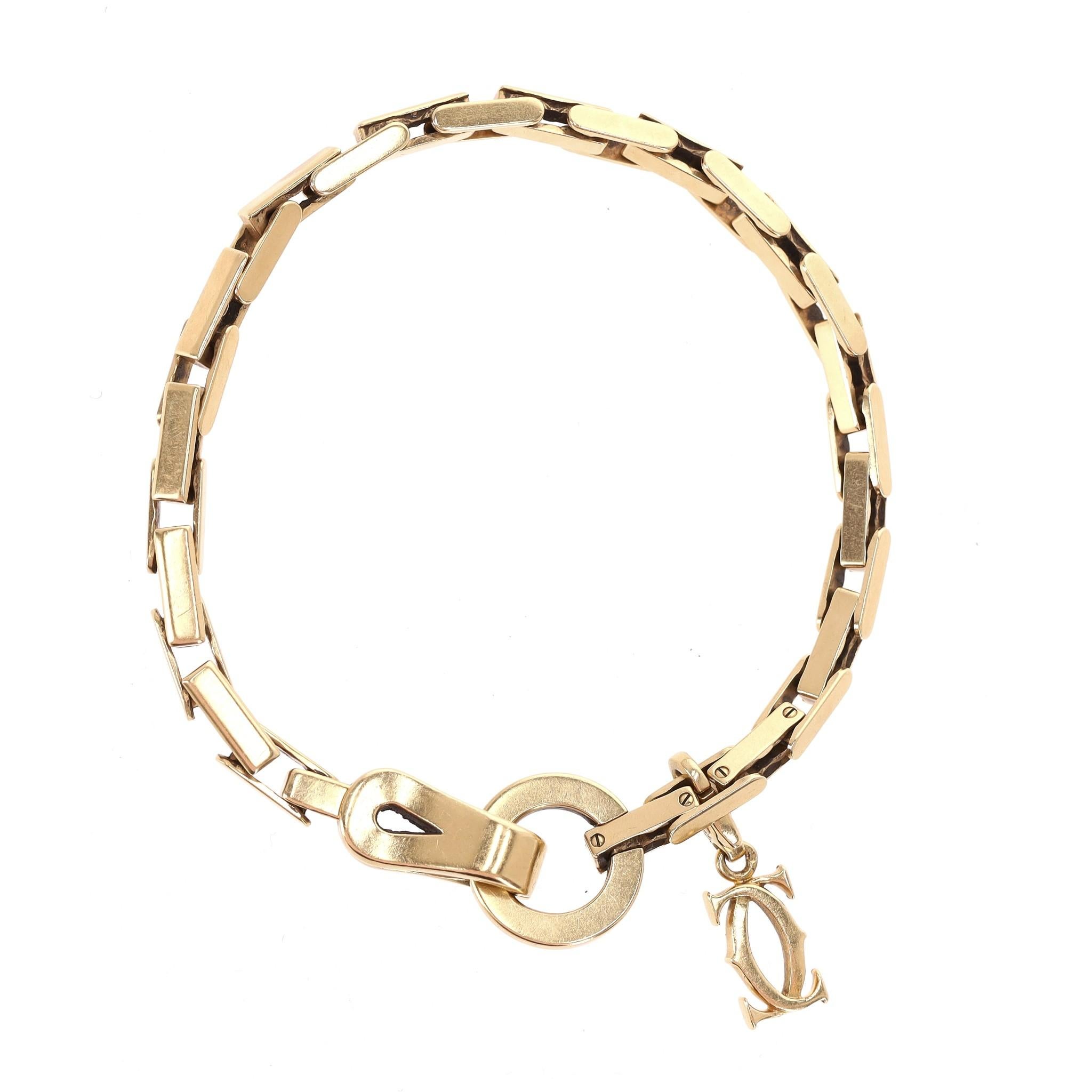 Women's Cartier 18k Gold Agrafe Bracelet With Cartier Logo Charm For Sale