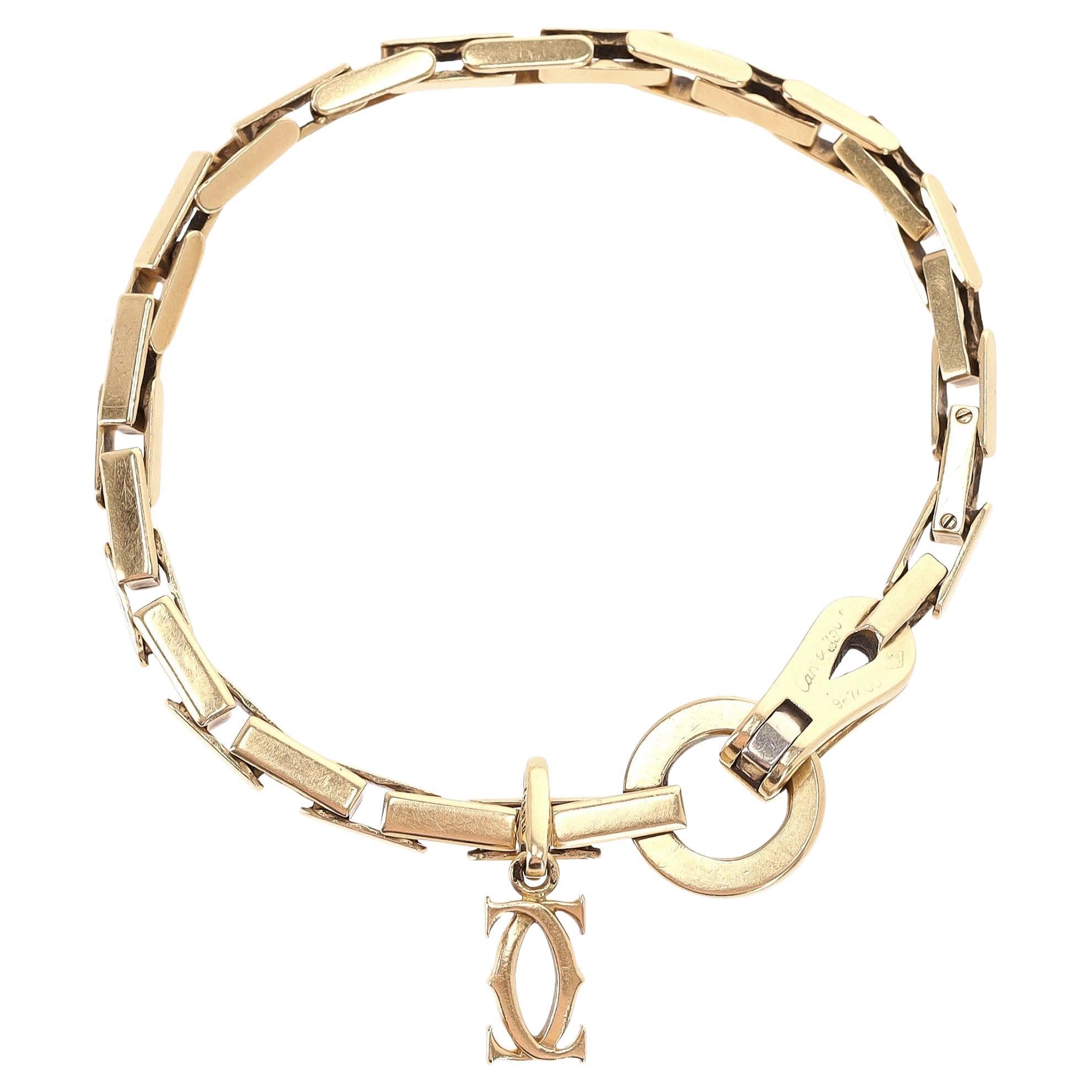 Cartier 18k Gold Agrafe Bracelet With Cartier Logo Charm