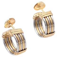 Boucles d'oreilles Cartier en or 18 carats et acier signées et numérotées des années 80.