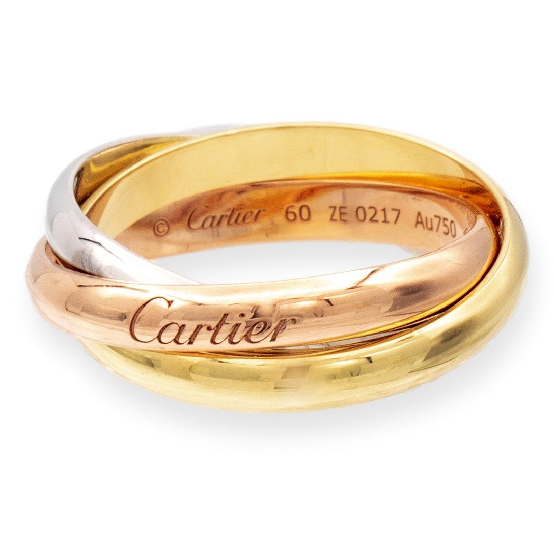Cartier ring from the Trinity collection finely crafted in 18 karat yellow, white and rose gold featuring three interlocking rolling bands measuring 3.3 mm wide each. Finger size is 60 ( Size 9 US ). Fully hallmarked with logo, serial numbers and