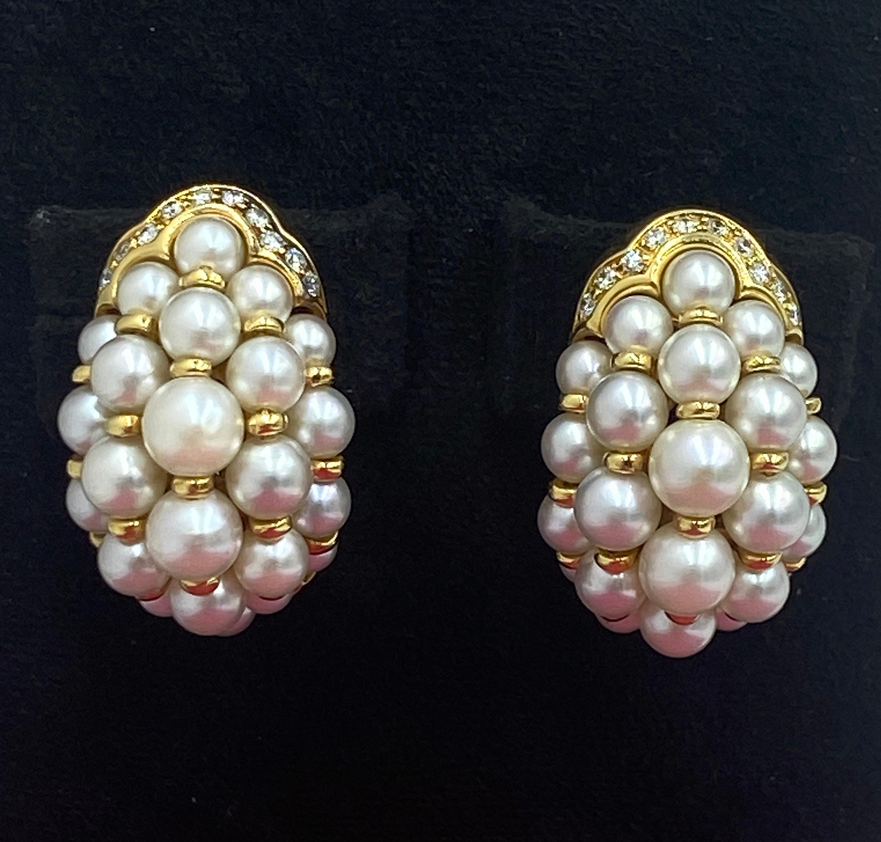 These elegant 18k gold, diamond and pearl clip on earrings by Cartier are marked with the date of production 1991.  They are a most beautiful pair of earrings which can be worn day and night.