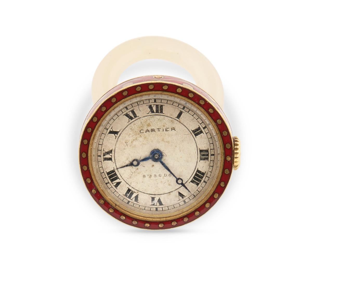 Cartier 18k Gold, Enamel, and Chalcedony Pendant Watch.

Art Deco; the round cream-toned dial with applied Roman numeral indicators; enclosing a manual-wind movement; signed on dial; bezel and case back set with red and black enamel completed by