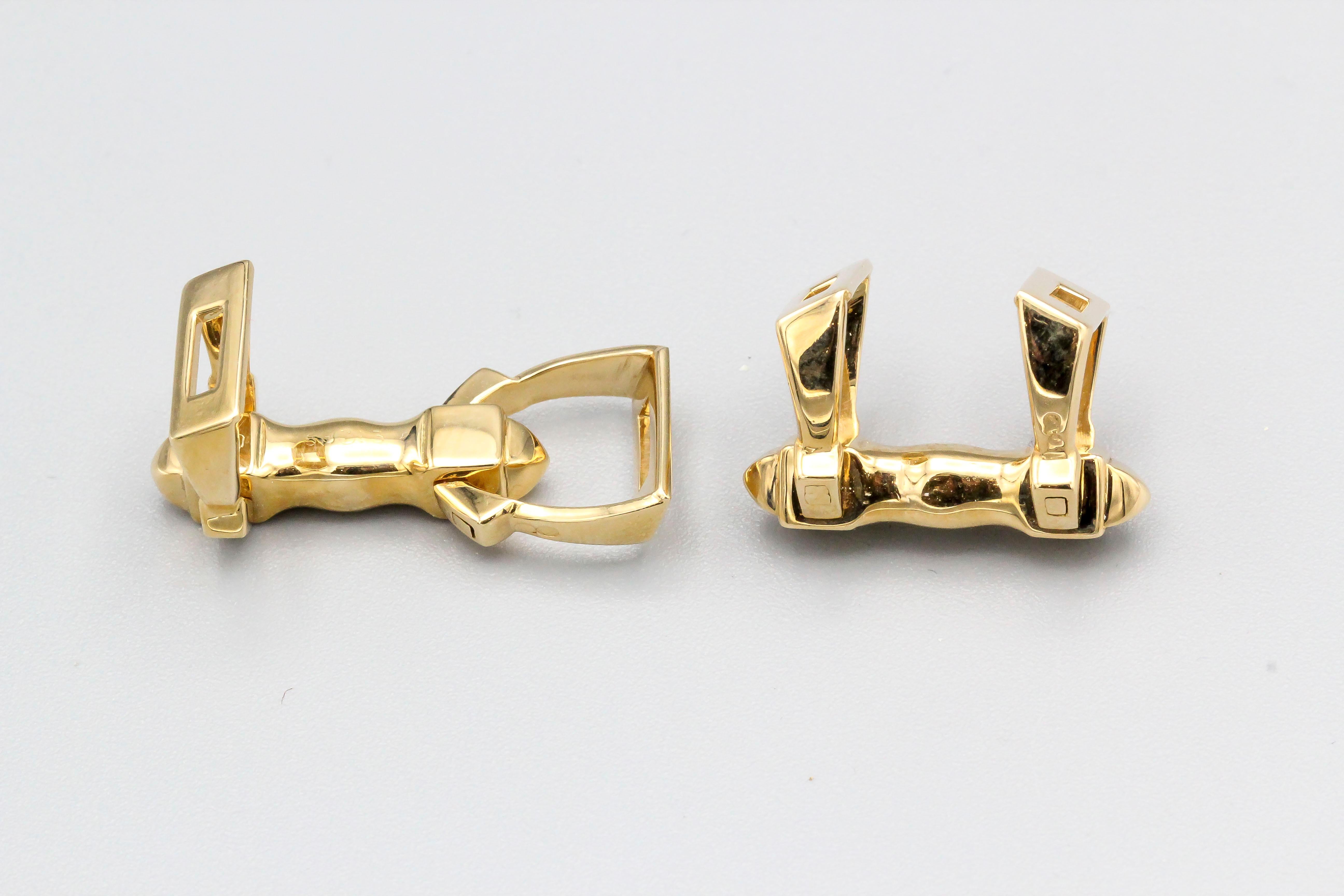 Handsome 18K yellow gold cufflinks by Cartier, circa 1980s.  They resemble horse stirrups. 

Hallmarks: Cartier, 750, reference numbers.

