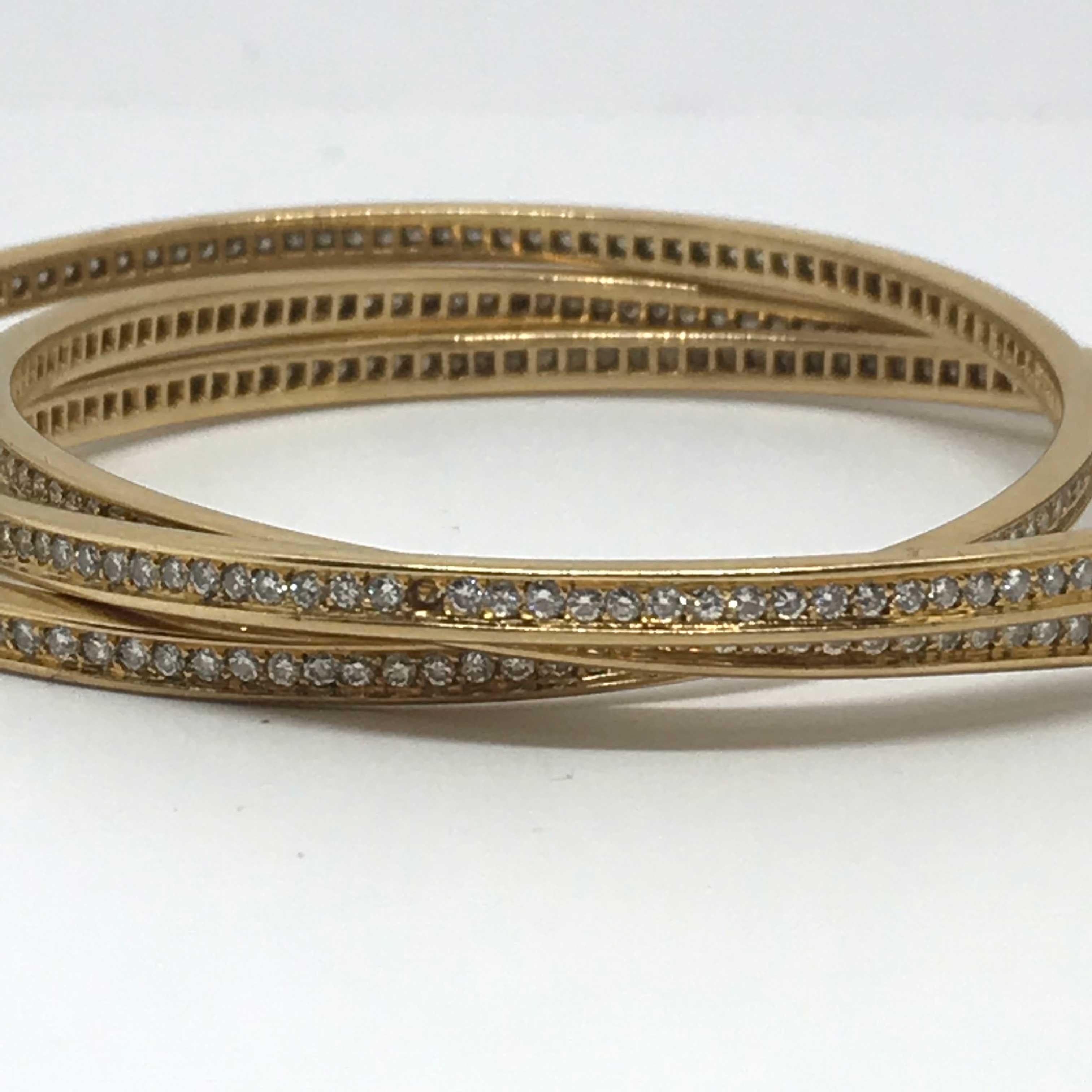 Amazing Vintage 3 Cartier bracelets in gold 18K. Cartier signature on it.
One diamond is missing (see pictures) Original vintage one.

Please find the measurements : 
Circumference (outside) : 23 cm
Circumference (inside) : 20,1 cm
Diameter : 6,7