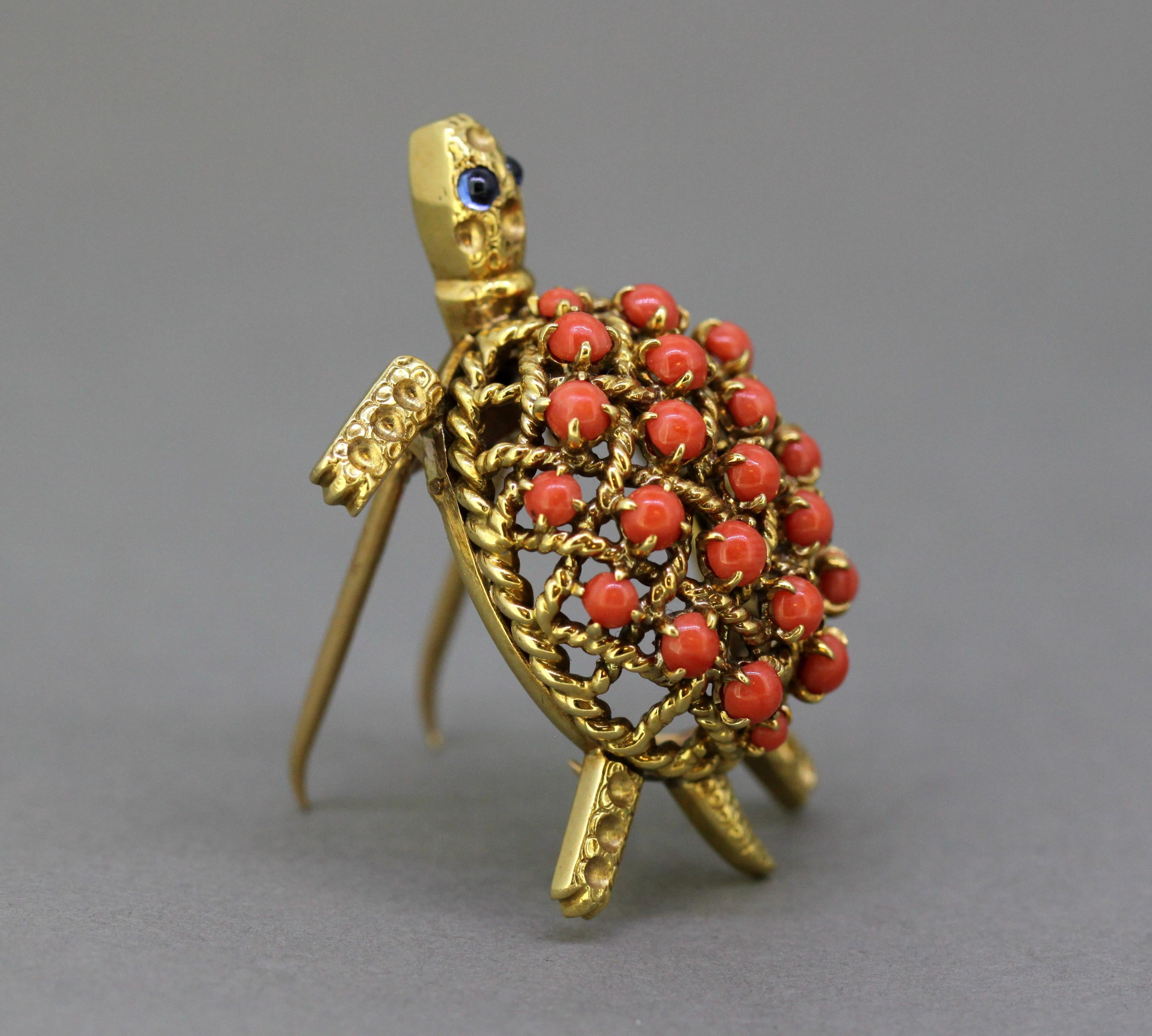 18k gold turtle brooch with natural coral and blue sapphires.
Designer: Cartier
Made in France Circa 1950's
Fully hallmarked. (Eagles head, Cartier, Paris)

Dimensions - 
Size : 3.9 x 2.7 x 1.5 cm
Weight : 15 grams

Coral - 
Cut : Round
Number of