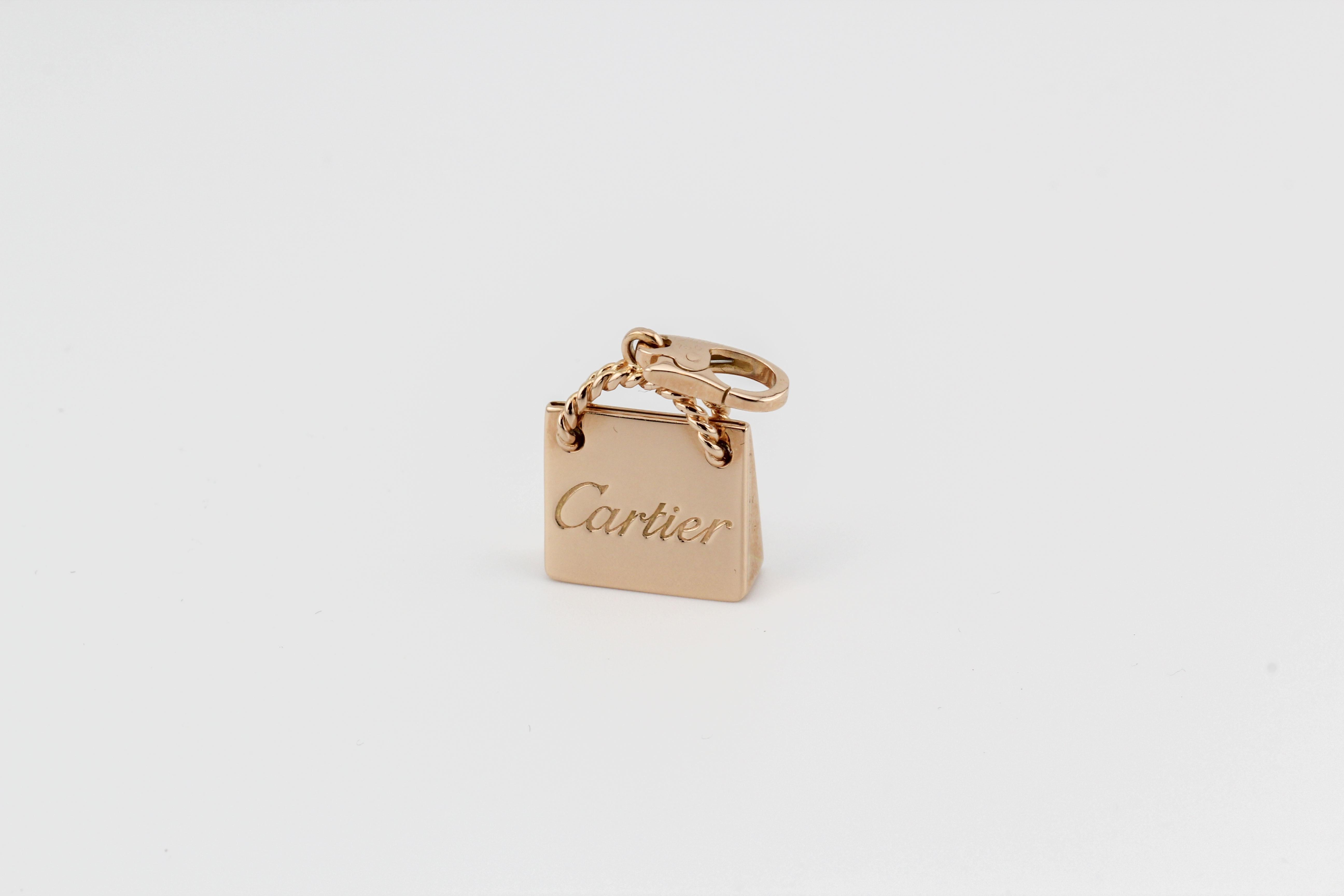 Introducing the Cartier 18K Pink Gold Shopping Bag Charm Pendant, a whimsical and luxurious jewelry piece that playfully captures the spirit of high-end shopping and elegance. This charming pendant is a delightful representation of Cartier's