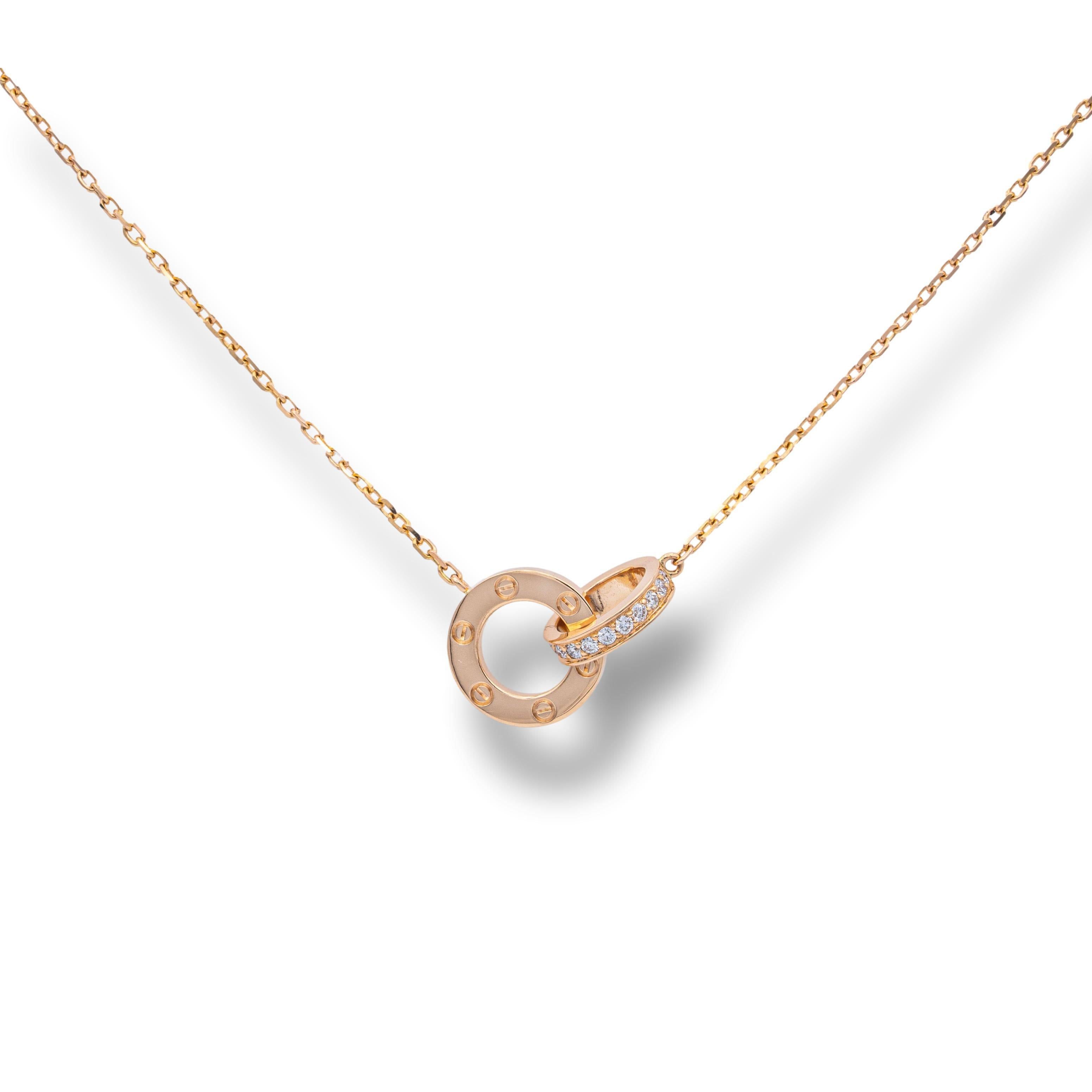 Cartier double ring necklace from the LOVE collection finely crafted in 18 karat rose gold with 48 round brilliant cut diamonds weighing 0.30 cts total. Necklace has an adjustable chain for lengths 14