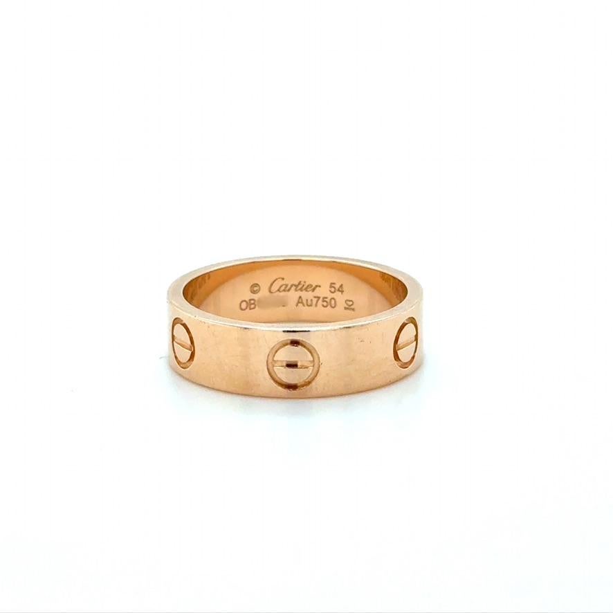 Cartier Love Ring
Classic Model
Stamp: Cartier 54 (Cartier Serial Number) Au750 SNOE
Cartier Ring size: 54
Ring Size: 6 3/4
Material: 18 karat rose gold
Gross weight: 5.90 grams

Accompanied by a Cartier box and receipt with folder.