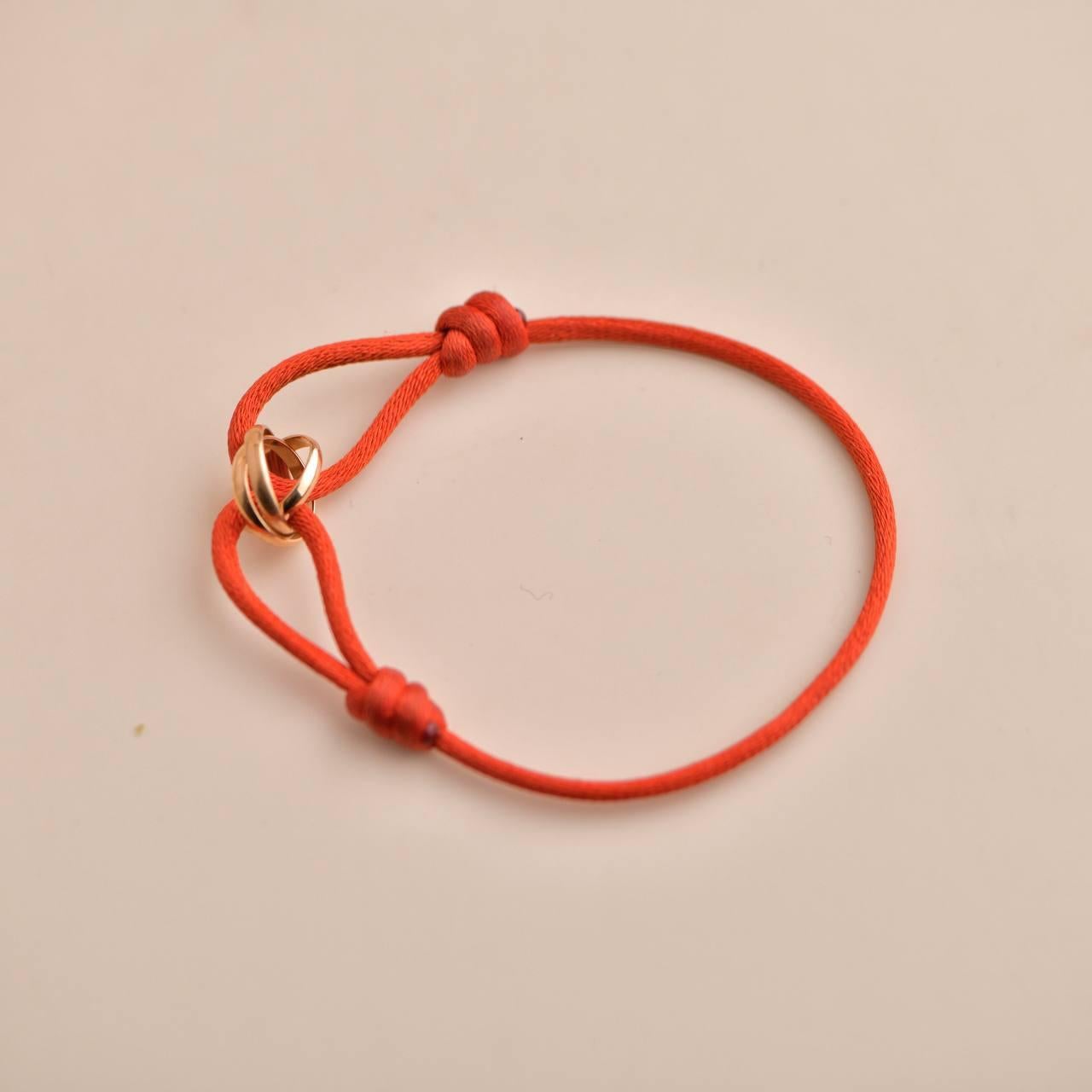 Women's or Men's Cartier 18K Rose Gold Trinity Red Silk Cord Bracelet For Sale
