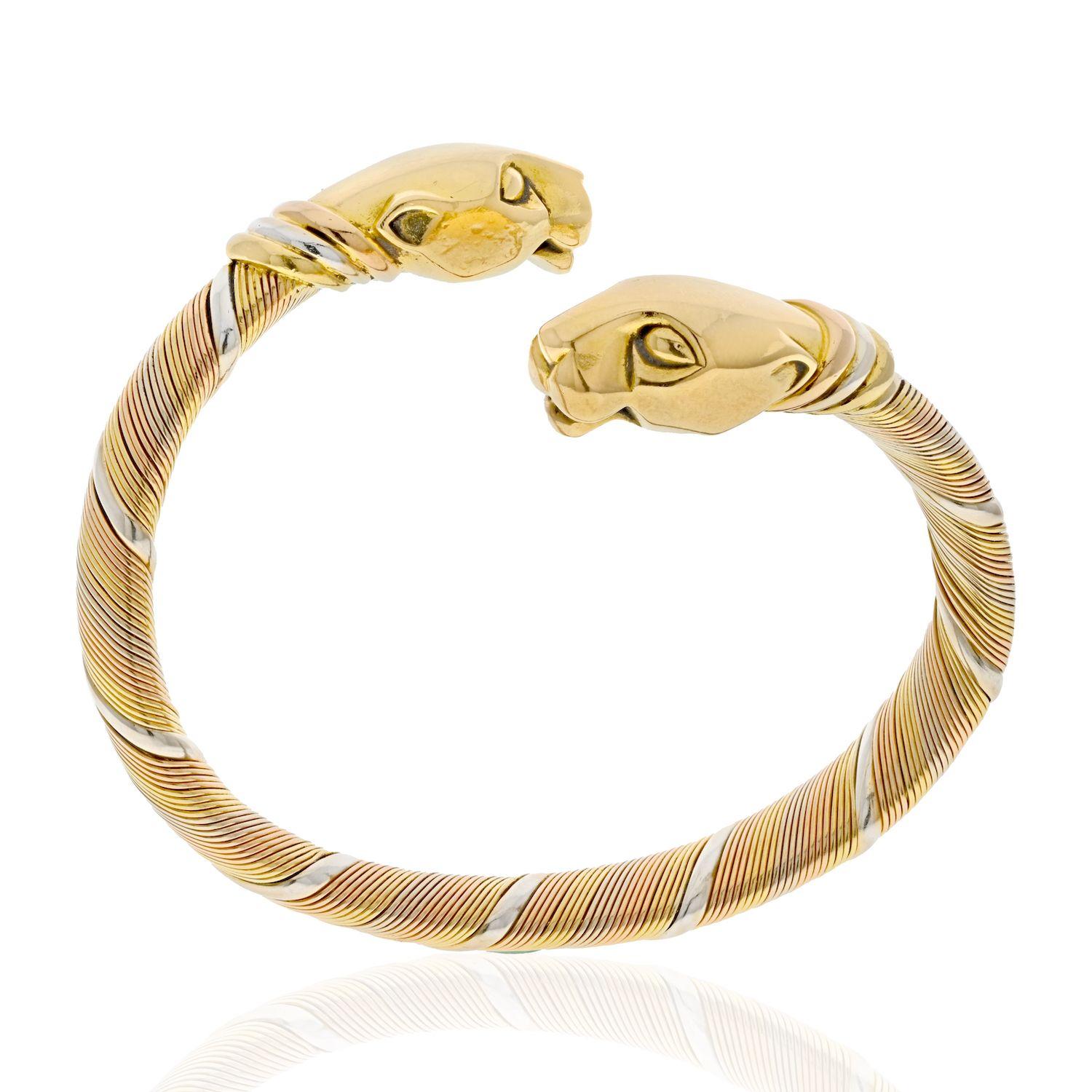 Cartier 18K Tri Color Double Cougar Vintage Panthere Cuff Bracelet.
Iconic design of two cougars on a coiled bracelet. 
Rare vntage Panthere De Cartier (Cougar) bangle bracelet crafted in coiled tri-color 18k gold. This bracelet features two solid