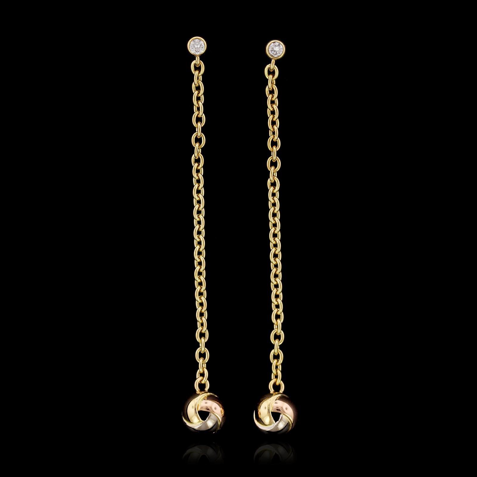 Cartier 18K Tricolor Gold Baby Trinity Diamond Earrings. The earrings
are set with two full cut diamonds, approx. total wt. .10cts., suspending two
trinity love knots, length 2 3/8