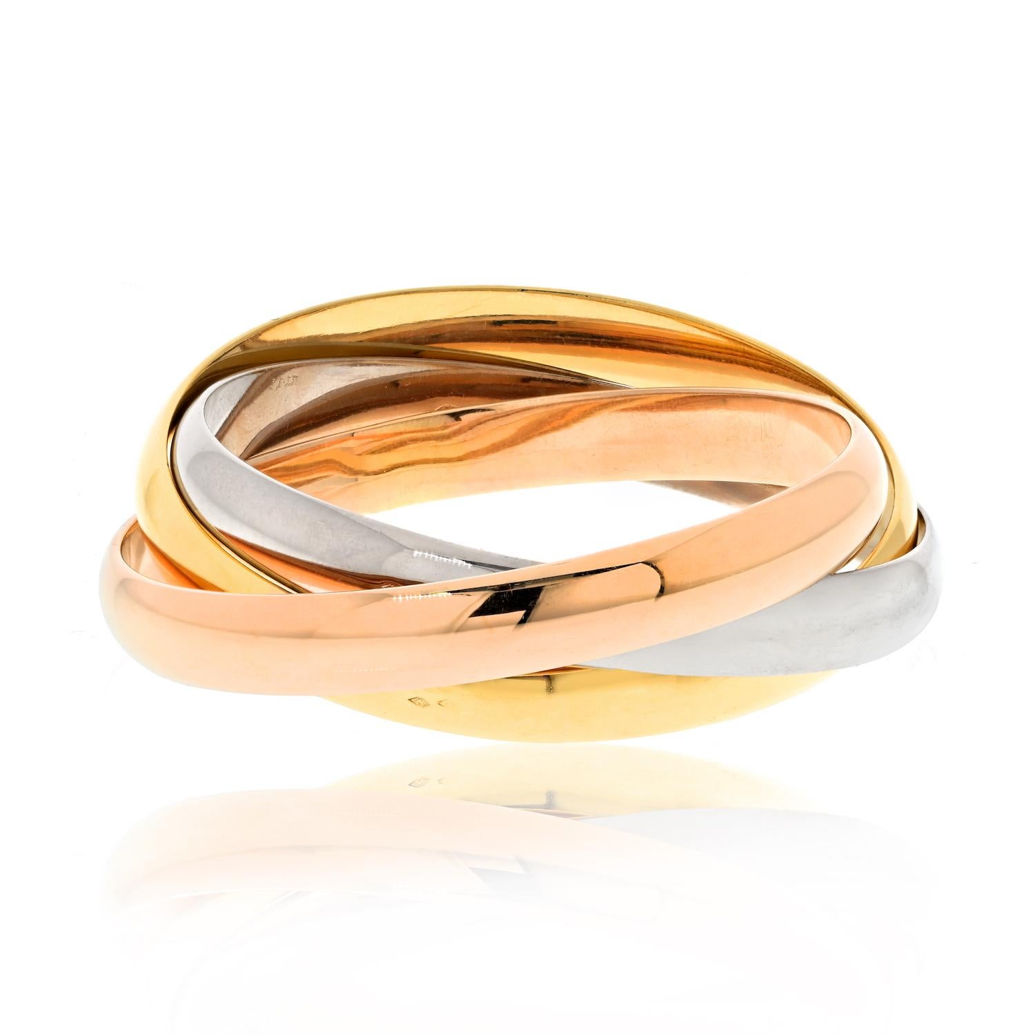 18k Tricolor Gold Trinity Rolling Bangle Bracelet by Cartier.

The 18k Tricolor Gold Trinity Rolling Bangle Bracelet by Cartier is a unique and iconic design. It features three interlocking bands in yellow, white, and rose gold, representing love,
