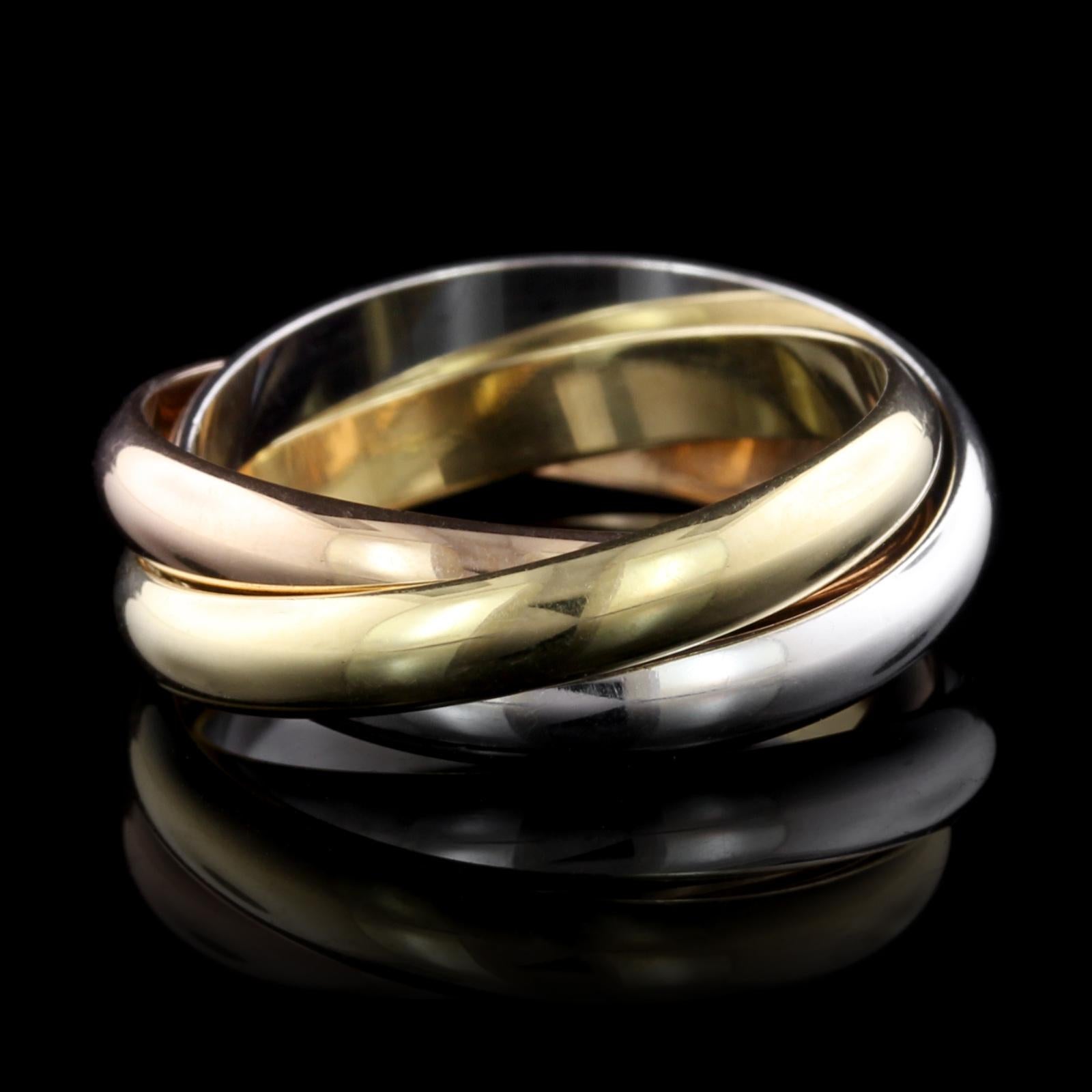 Cartier 18K Tricolor Gold Trinity Rolling Ring. The ring is designed with three
interlaced 3.50mm. bands symbolizing love, fidelity and friendship, #HW6255,
size 59, U.S. size 8 3/4.