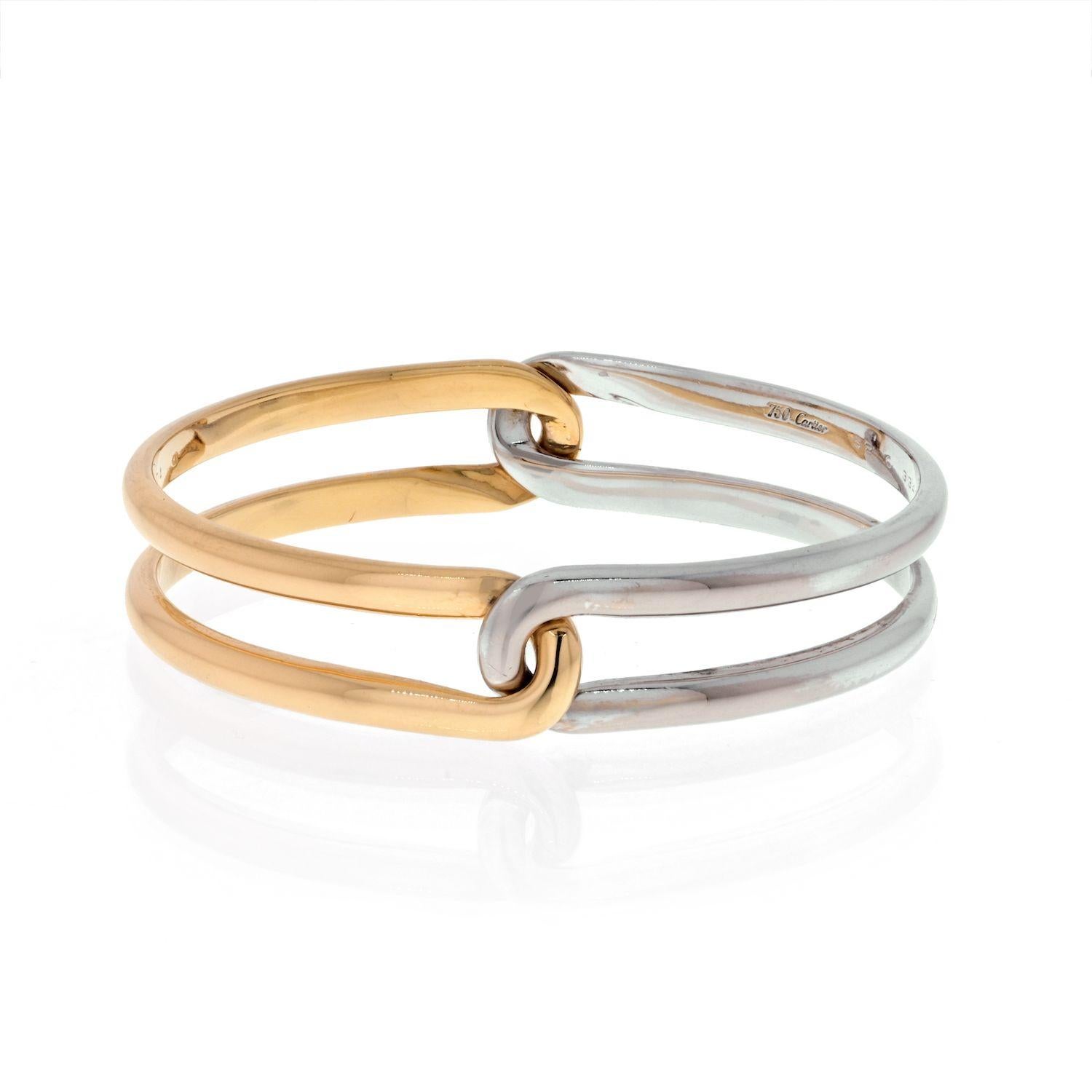 Crafted in 1994 this bracelet is by the famous house of Cartier.
Made in two tone 18k gold, this slip on bracelet is a perfect fit for wrist size 17.
The mechanism of the bangle is easy to assemple and disassemble creating a fun piece of jewelry for