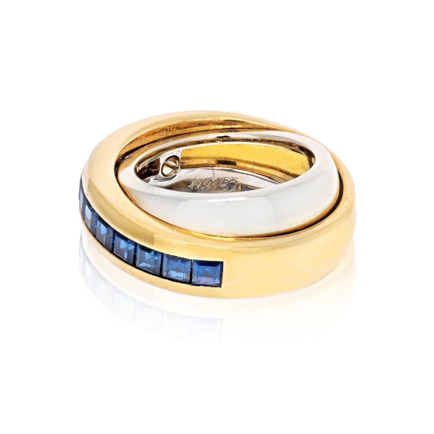 This Cartier double band ring in bi-color gold and sapphires is stylish and modern, dating from the 1990s. The upper yellow gold band is channel-set with a central line of nine square step-cut sapphires, sitting above a plain polished broad band of