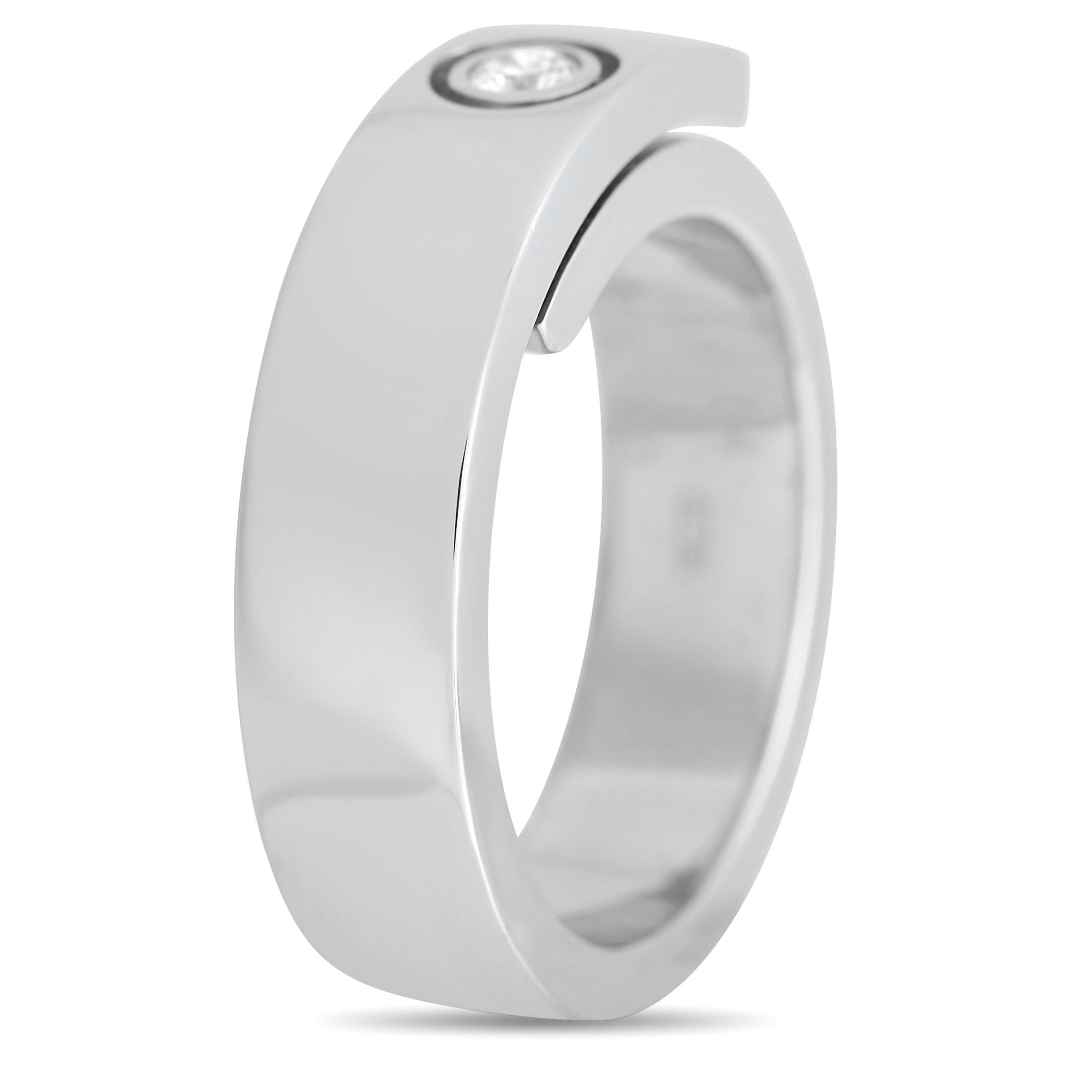 Proving that less is more is this Cartier Anniversary band. The ring is crafted in 18K white gold and features an overlapping band design. The band measures 6mm and weighs 12.8 grams. It bears a single bezel-set round brilliant-cut diamond for