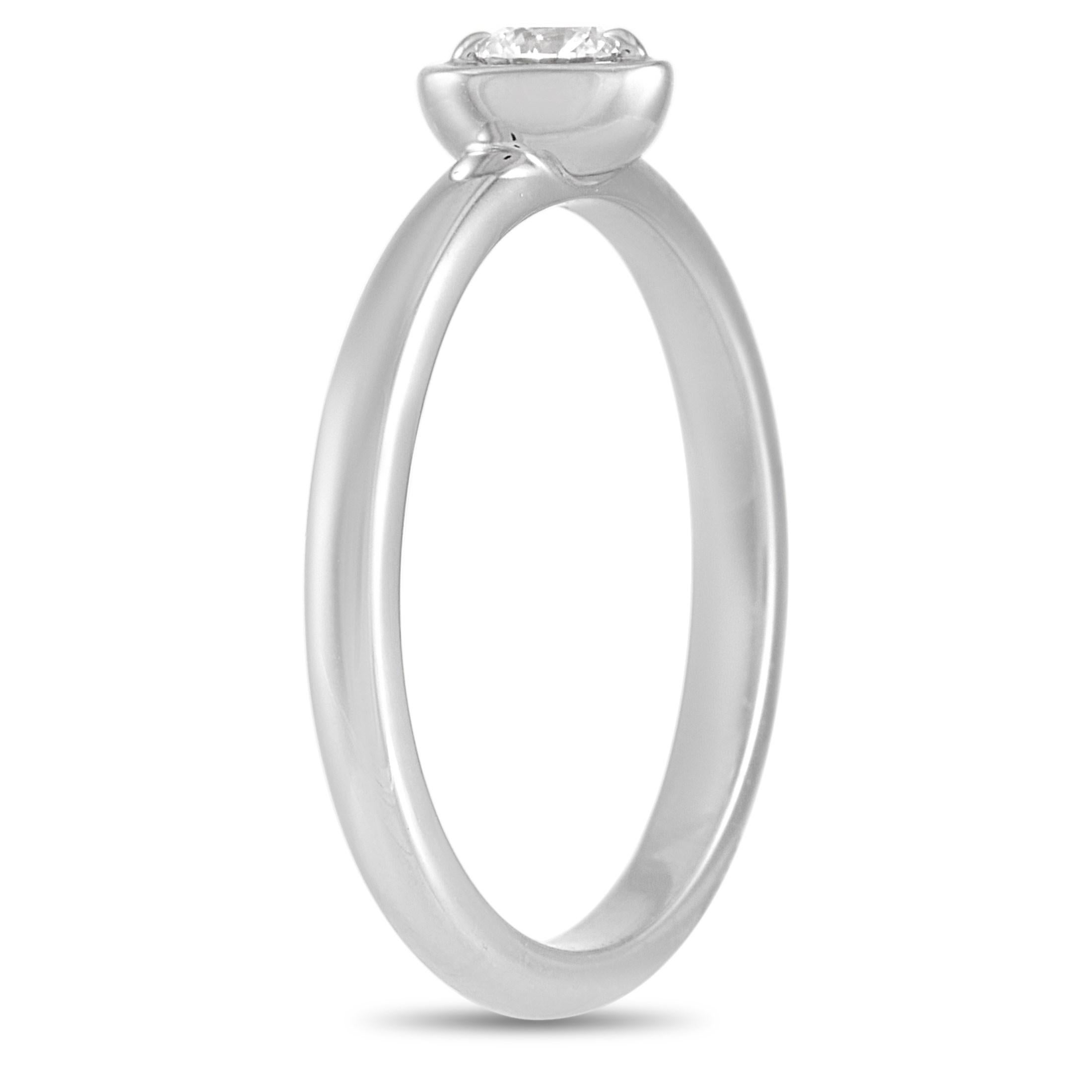 This Cartier 18K White Gold 0.12 ct Diamond Heart Ring puts a cute twist on the classic Diamond Solitaire Ring. The simple band is made with 18K white gold highlighting a 0.12 carat round-cut solitaire diamond set in a white gold heart and held in