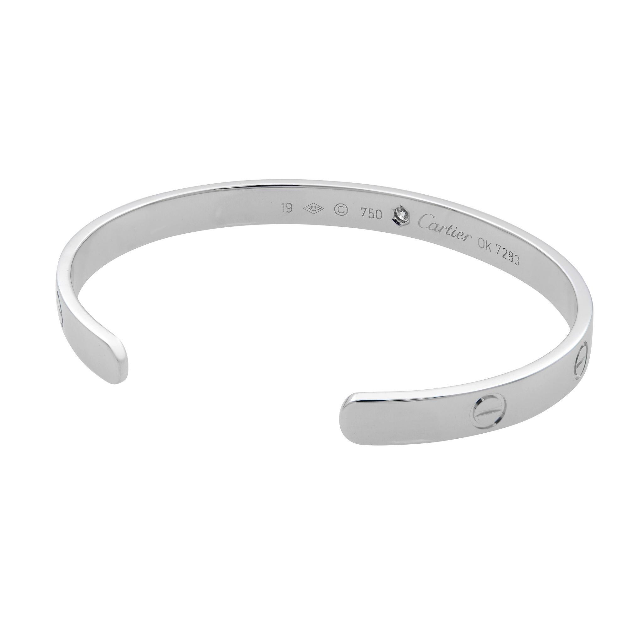 This beautiful Cartier open cuff bracelet from the Love collection is a perfect wrist accent. 18K white gold, set with 1 brilliant-cut diamond totaling 0.10 carats. Width: 6.1mm. Size 19. Unworn condition. Original box and papers are not included.