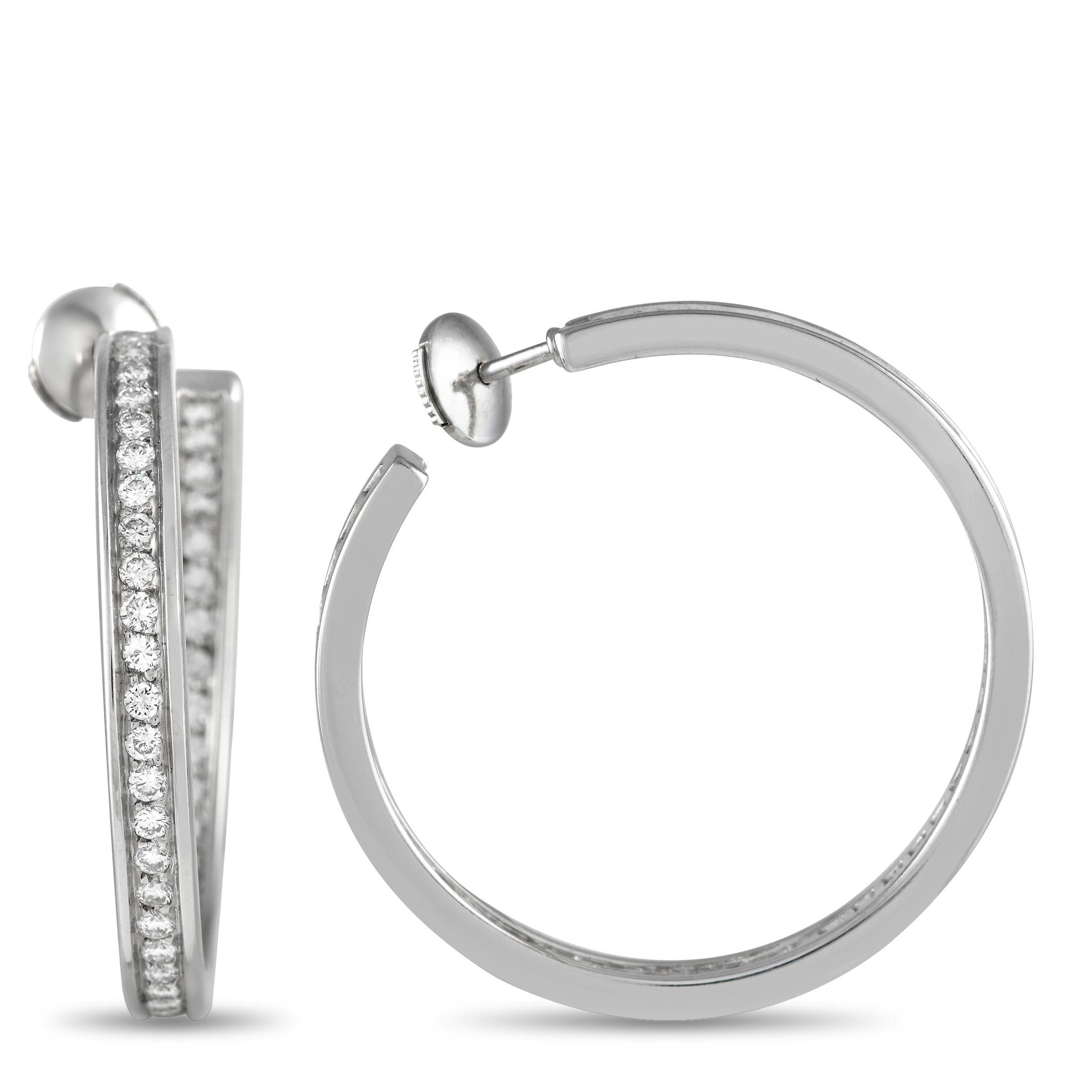 These Cartier hoop earrings will never go out of style. Each one features a simple, elegant 18K White Gold setting measuring 1.25 long by 0.25 wide. Diamonds with a total weight of 3.0 carats add additional sparkle.This jewelry piece is offered in