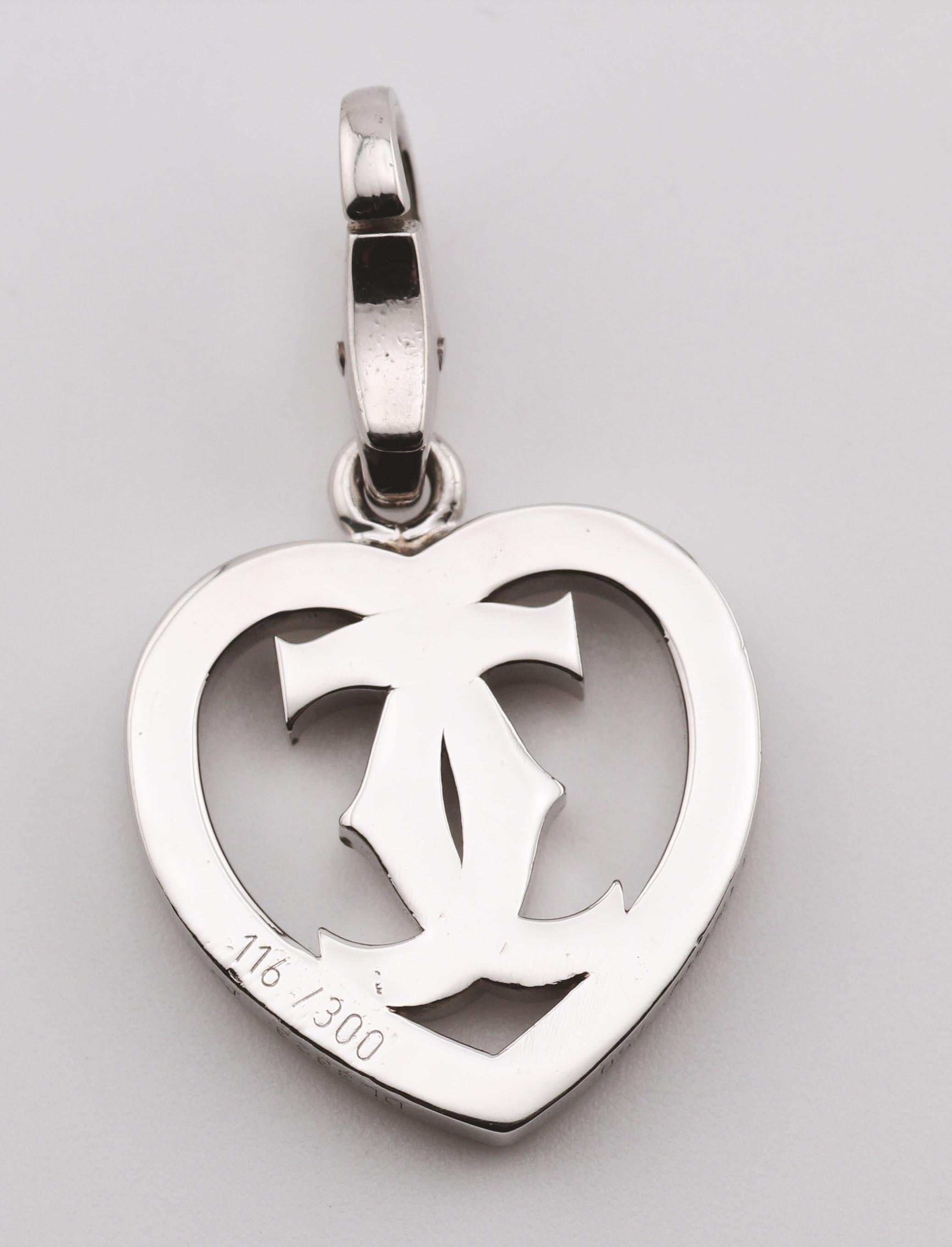 The Heart Charm is a sophisticated and elegant accessory, designed to charm with its sleek and polished appearance. Crafted with precision, this pendant features a heart motif intertwined with a distinctive double-C design, creating a harmonious and