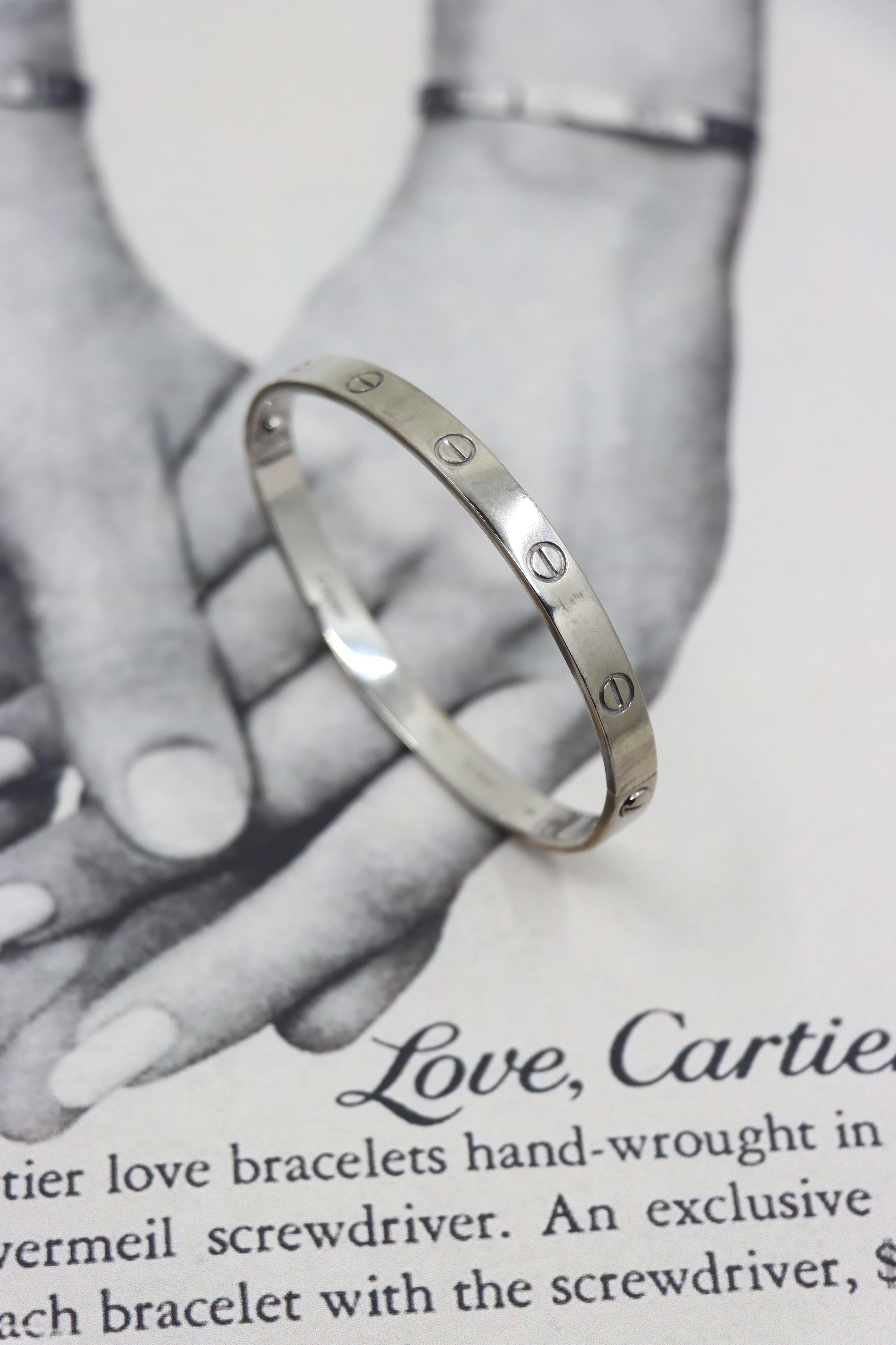 Cartier 18K White Gold Classic LOVE Bracelet
With Original Box

Marked:
CARTIER
750

Approximate Dimensions:
18 (circumference)
0.5 cm (Width)
36.1 grams in weight.