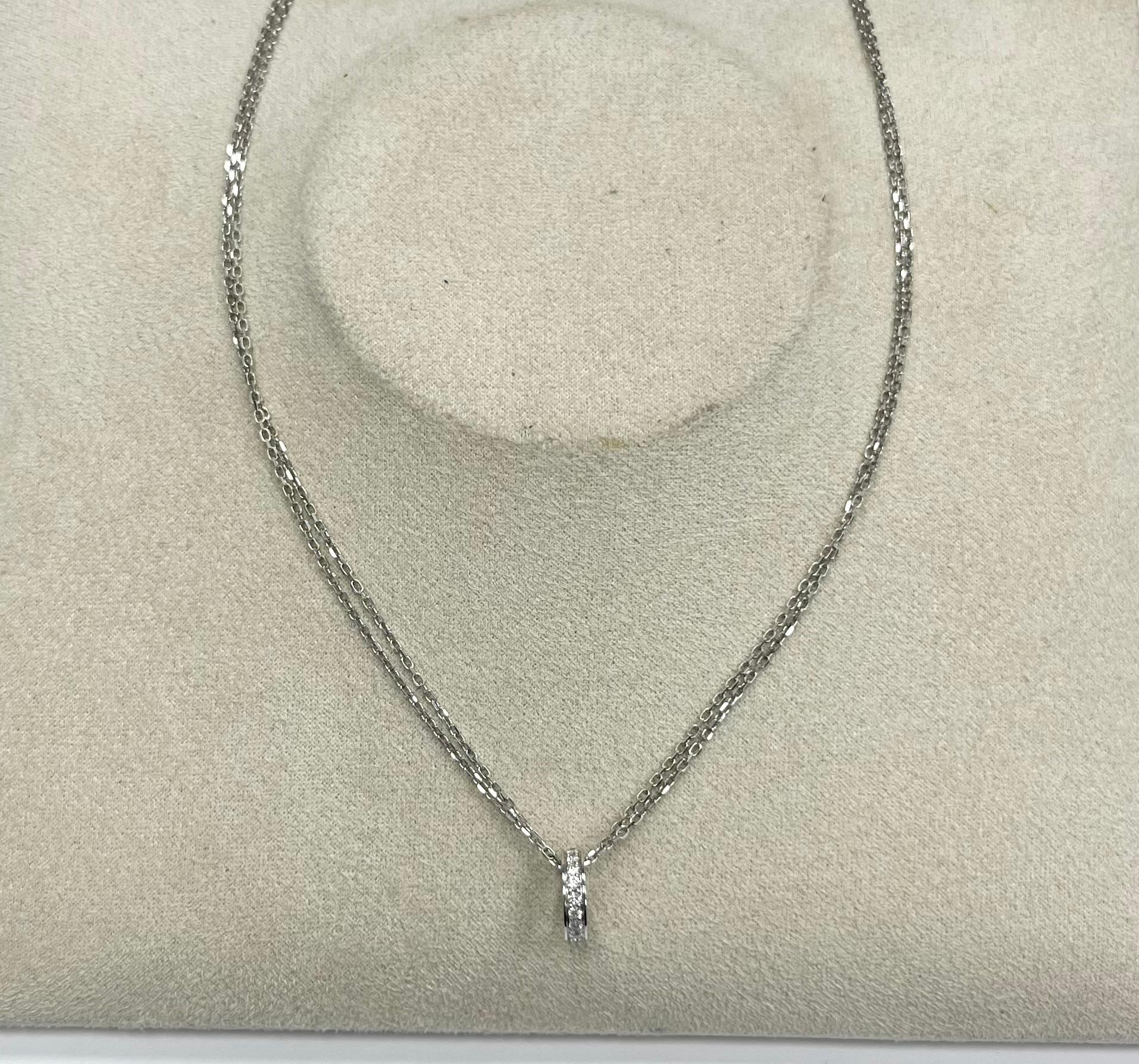 Cartier 18K white gold diamond circle pendant with a double chain necklace
Marked: Cartier Au750 and serial number
Length: 15.25