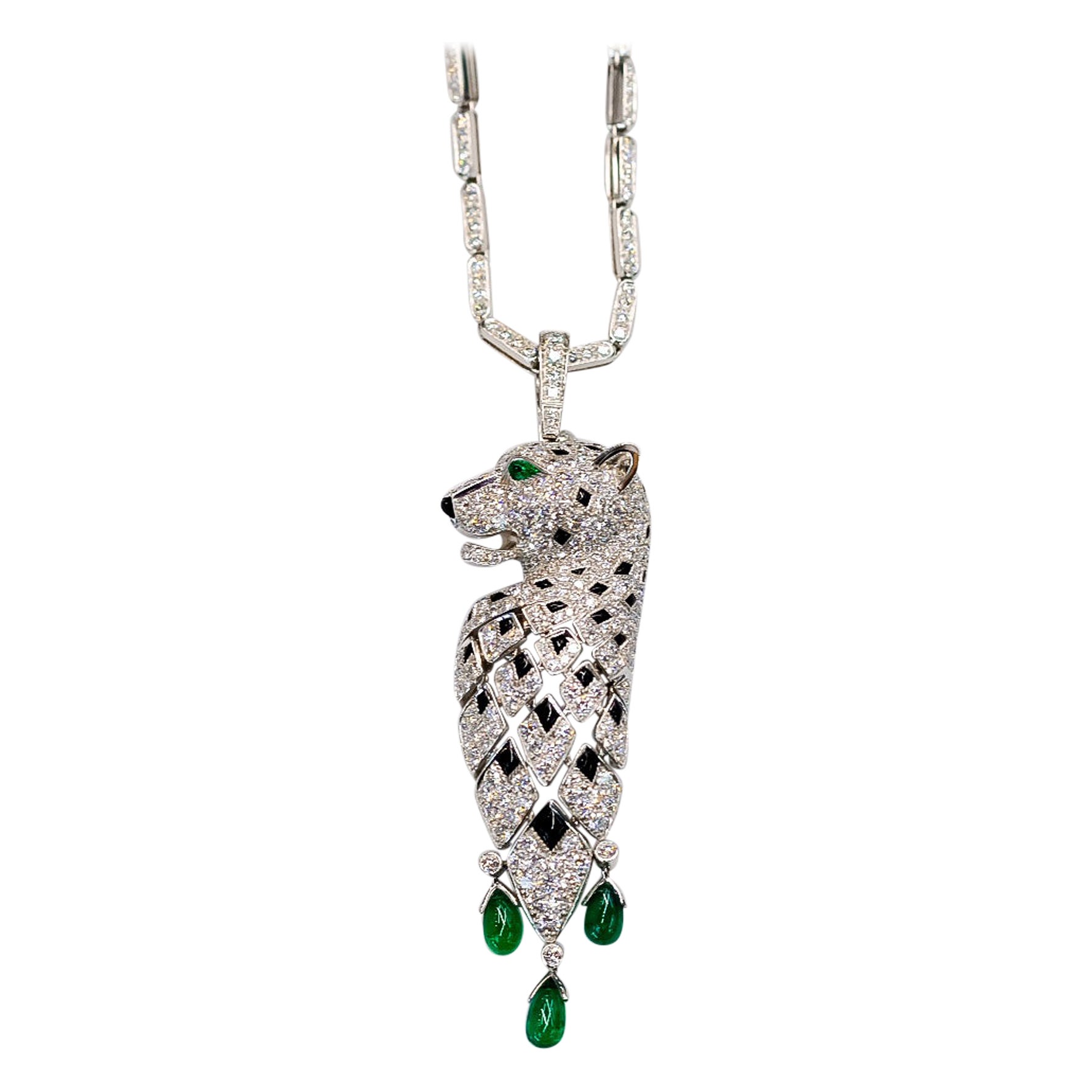 Designed as a panther embellished with pave-set circular-cut diamonds and onyx spots and emerald eyes, suspending three emerald drops, brilliant cut diamonds, mounted in 18K gold, panthere pendant length approximately 8cm, signed Cartier.

The chain