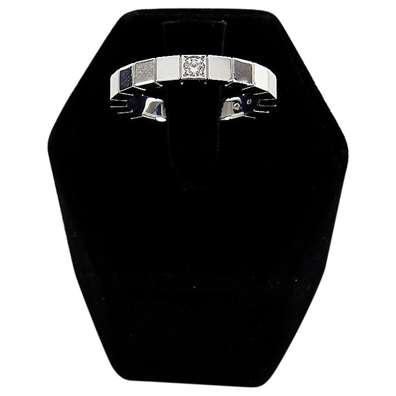 Cartier 18k White Gold Diamond Lanieres Band Ring.  Segmented thin band ring in 18k white gold with one single white diamond and Cartier script logo at back. Measures 3mm wide.  Size 53 (USA 6.5). Catalogue picture shown depicts same ring without