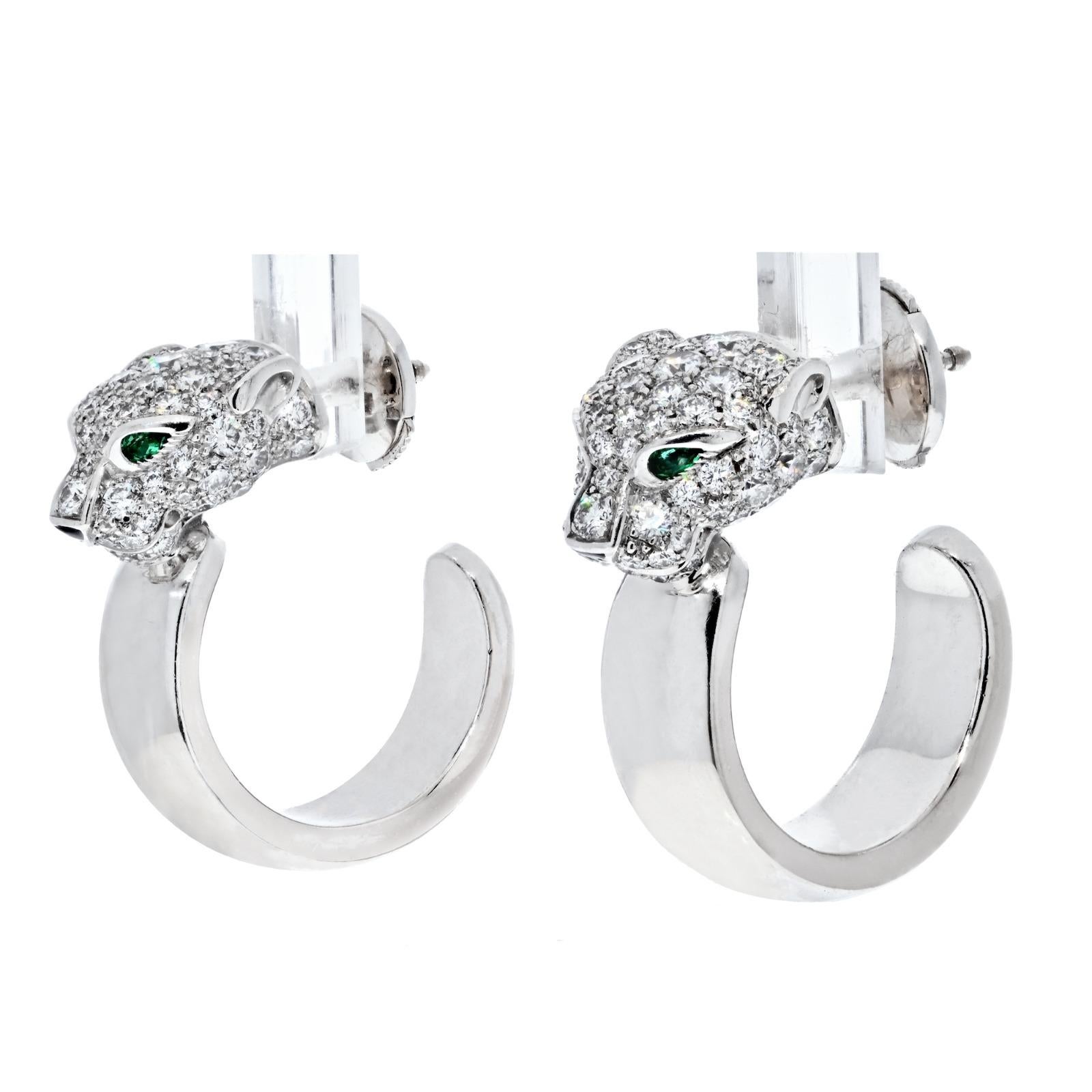 Cartier White Gold, Emerald and Diamond Panthère Earrings.
The earrings designed as panthers whose eyes are set with emeralds and whose heads are pavé set with diamonds, the heads resting on white gold hoops.

Diamonds weighing a total of