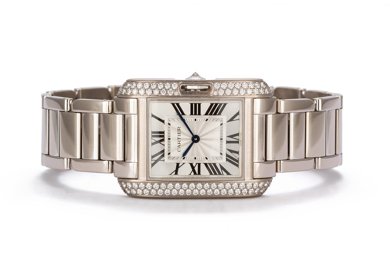We are pleased to offer this Authentic Cartier 18k White Gold Tank Anglaise With Diamonds. The Cartier Tank Anglaise watch (ref. WT100028) features a Swiss-made quartz movement; silvered and lacquered flinqué dial with black Roman numerals and
