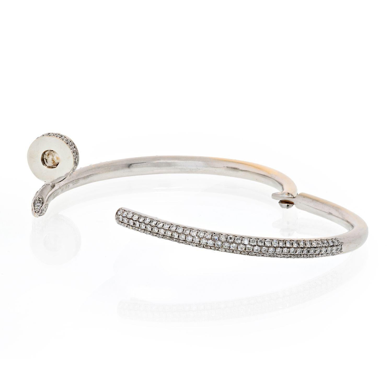 A stunning 18k white gold diamond bangle by Cartier from the Juste Un Clou collection. The bangle is of a nail design, fully pave set around the outer side with 374 round brilliant cut diamonds totaling 2.26ct. The bangle is a size 18 and has the