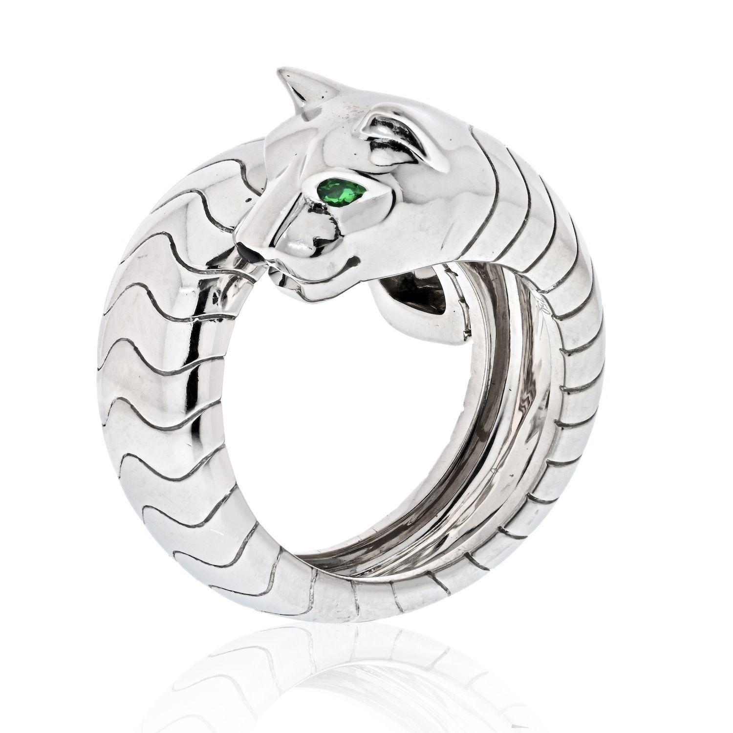 A stunning Cartier 18k white gold Lakarda Panthere ring from the Panthere de Cartier collection. The wrap around style ring comprises of a panther motif with emerald eyes, an onyx nose. The ring measures 8.33mm wide, is a size 52 and has a gross