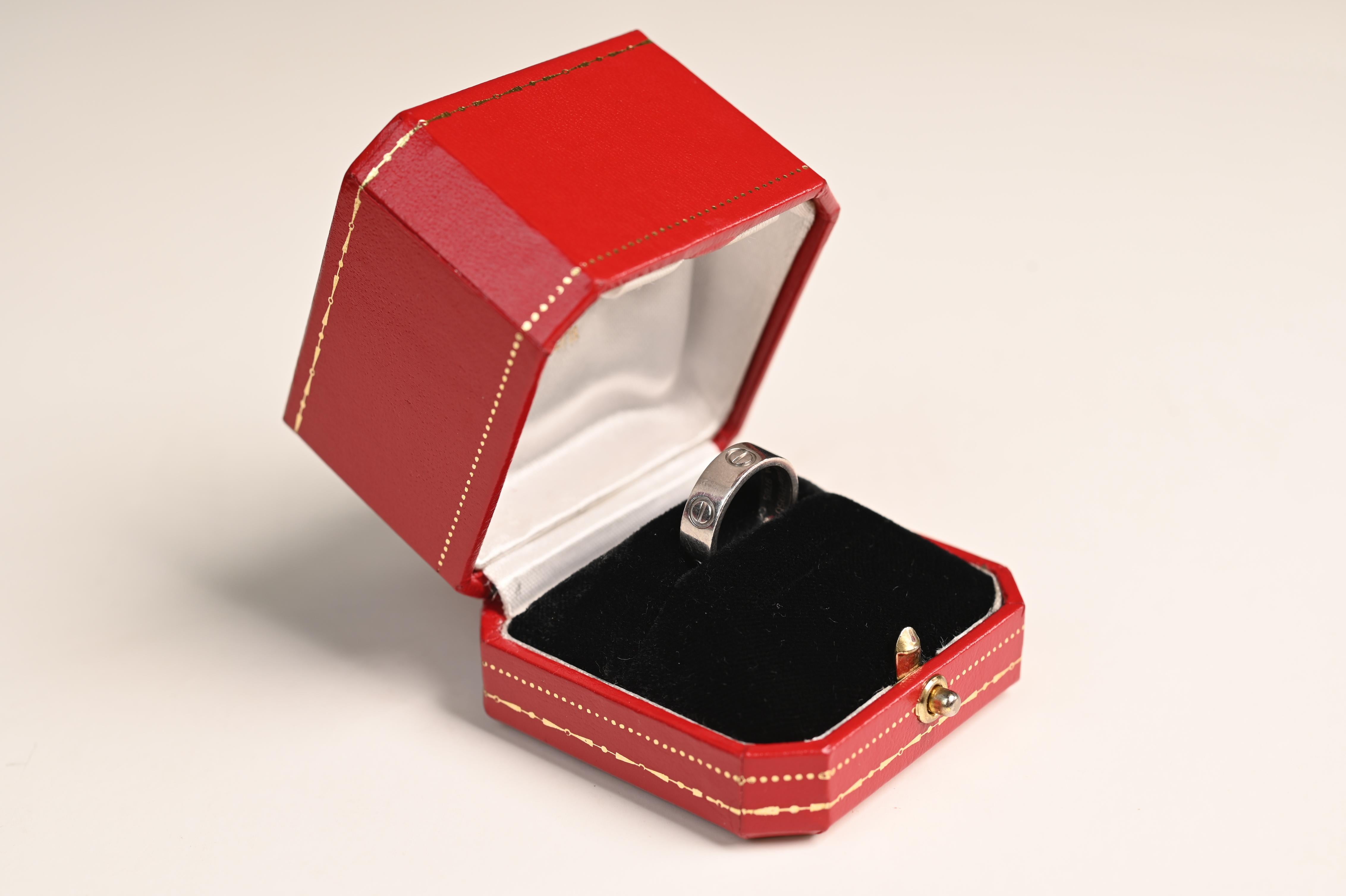 Esta exquisita Love Band de Cartier, meticulosamente elaborada en oro blanco de 18 quilates, ejemplifica la elegancia atemporal y el lujo asociados a la emblemática marca Cartier. La banda presenta los característicos motivos de tornillos grabados,