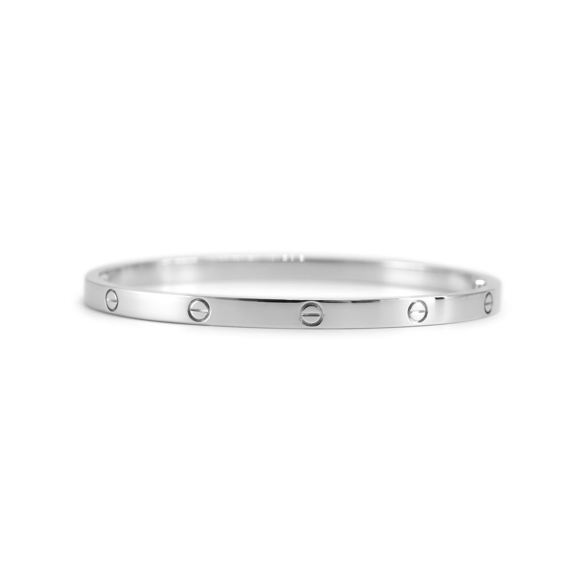 Brand: Cartier

Gender: Ladies

Metal Type: 18K White Gold

Length: 5.75 inches

Width: 3.65 mm

Weight: 18.80 grams

One ladies designer made polished 18K white gold bangle bracelet. The metal was tested and determined to be 18K white gold.