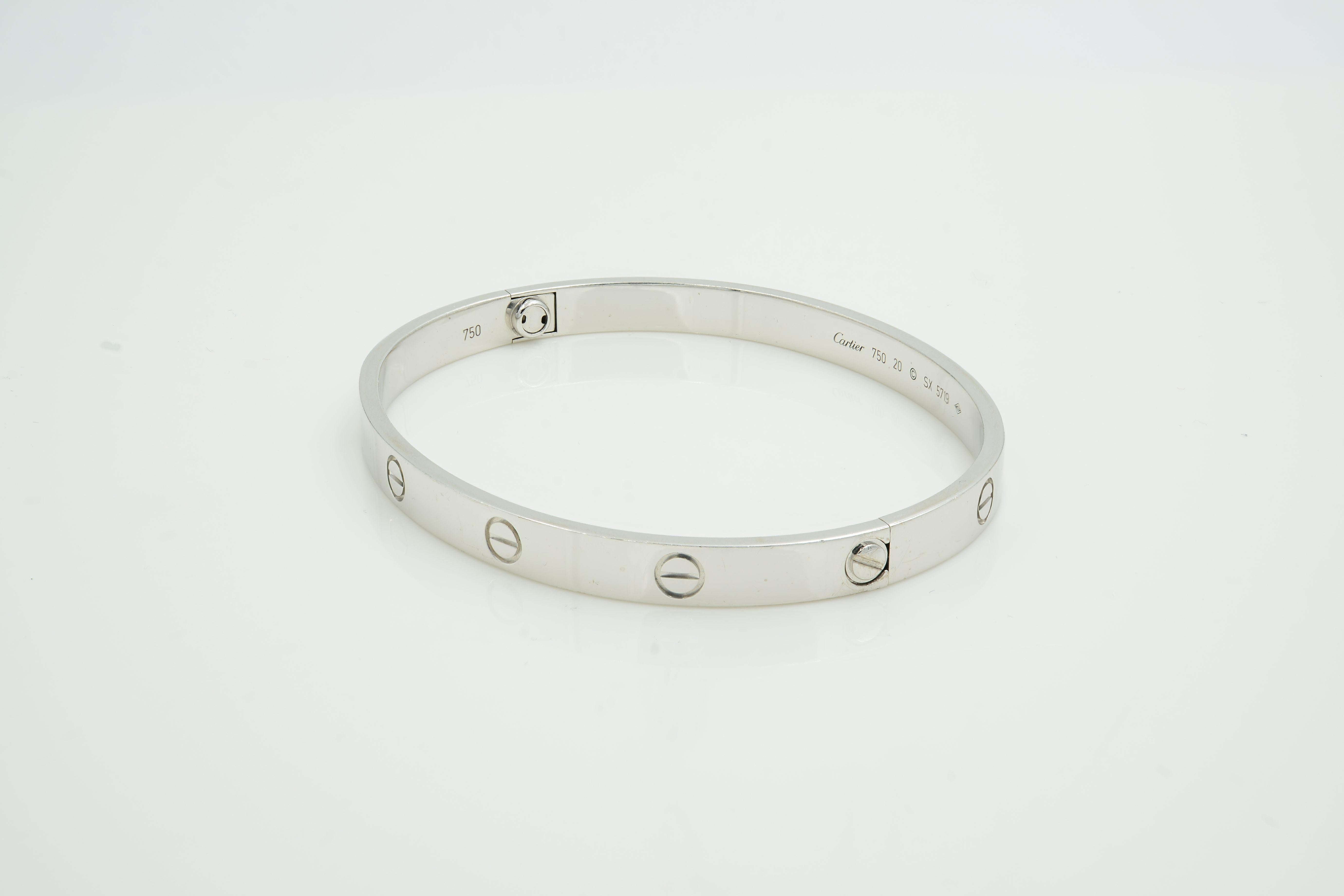 100% Authentic Cartier Love Bracelet Size 20 18K White Gold. 
Comes with original Cartier box screwdriver but no papers. 
Metal Type: 18K Gold
Hallmark: 750, Serial Number 
Metal Finish: High Polish
Collection: Love
Condition: Very good. 
New screw
