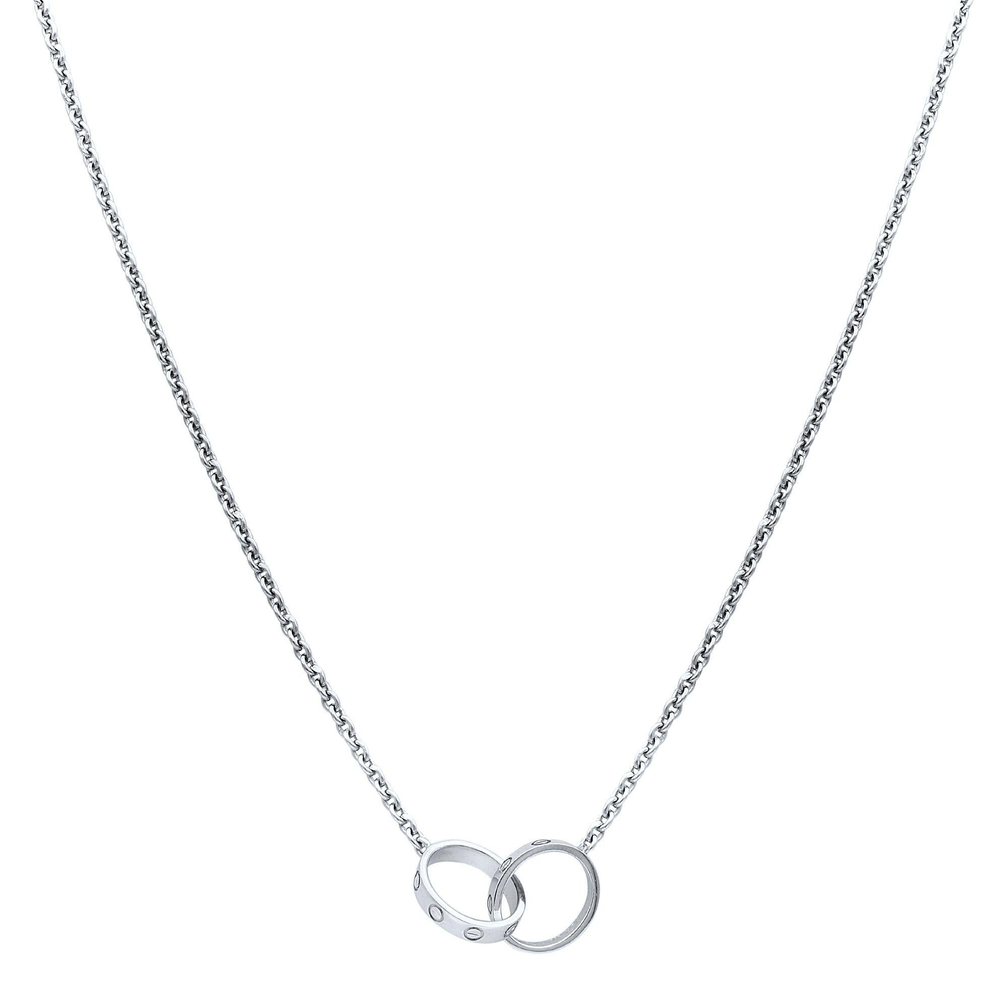 Cartier Love necklace, 18K white gold. The necklace features two interlocking circular motifs in the center, displaying the iconic screw motif throughout the center. Inner diameter 8mm. Chain Length: 17 inches. 
Excellent pre-owned condition, box