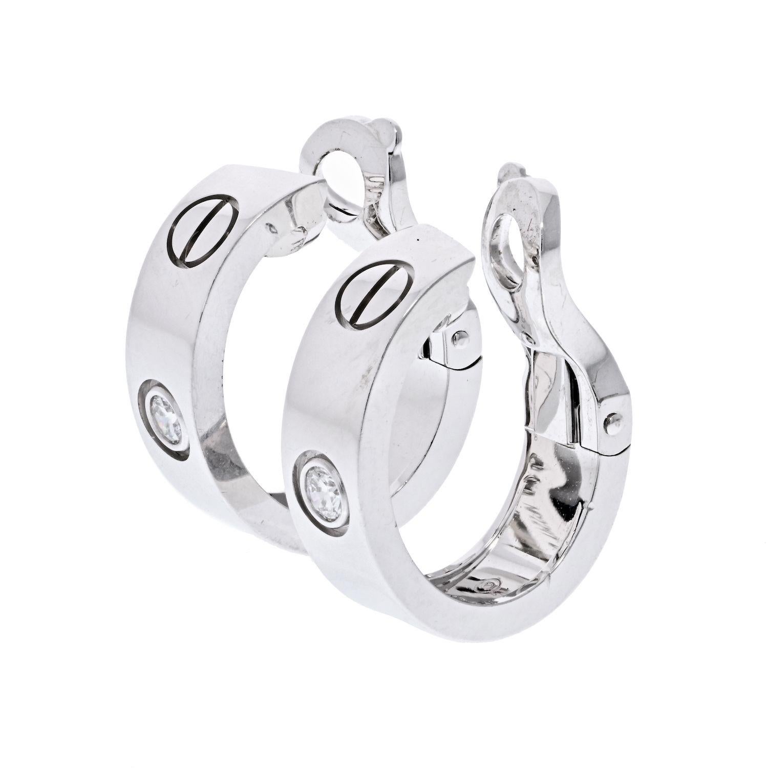 Cartier Love hoop earrings are crafted from 18k white gold and feature 2 0.15 total carat weight brilliant cut diamonds, the iconic screw motifs, and Omega backings.
W: 5.7mm