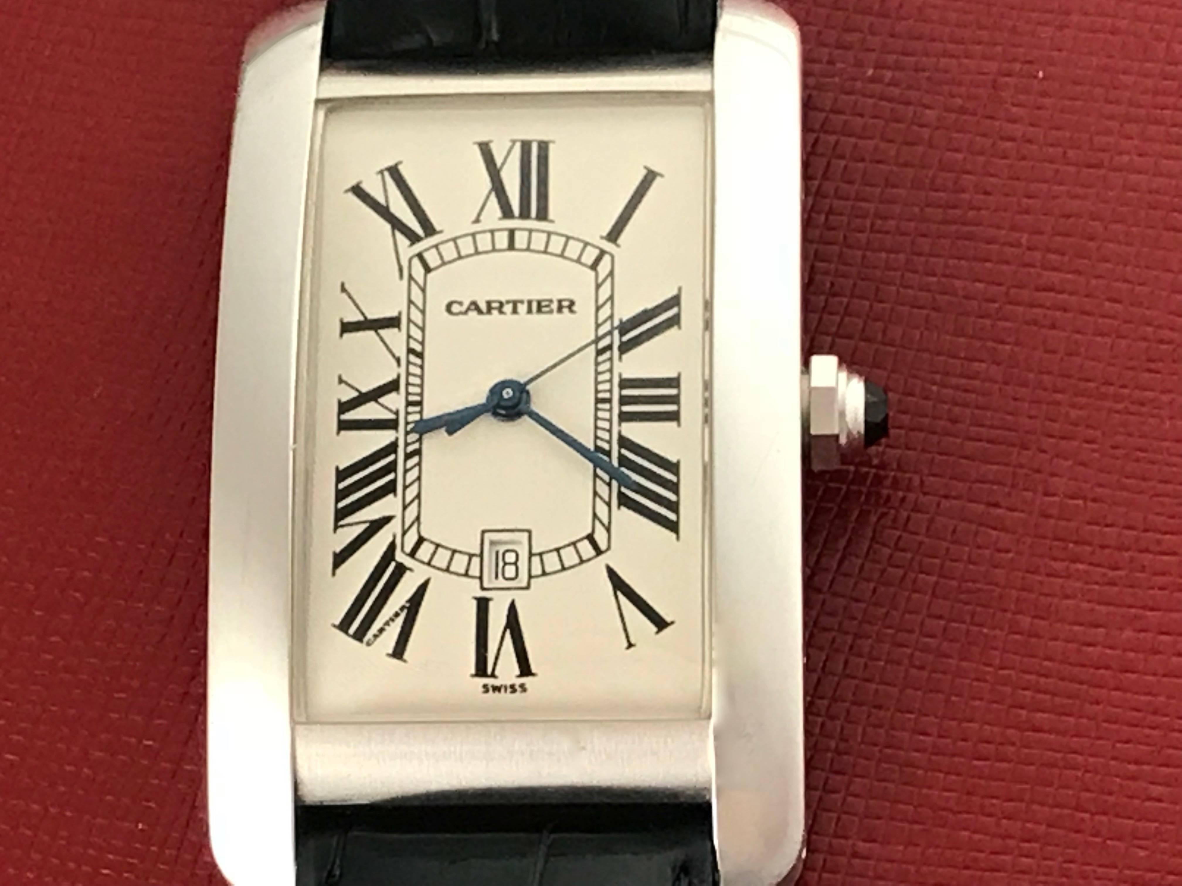Cartier Tank Americaine Model W2603256 Pre Owned Automatic Wrist Watch. Silvered guilloche Dial with black Roman numerals, 18k White Gold rectangular style case with sapphire cabachon setting crown (26x44mm). Black alligator strap with 18k White