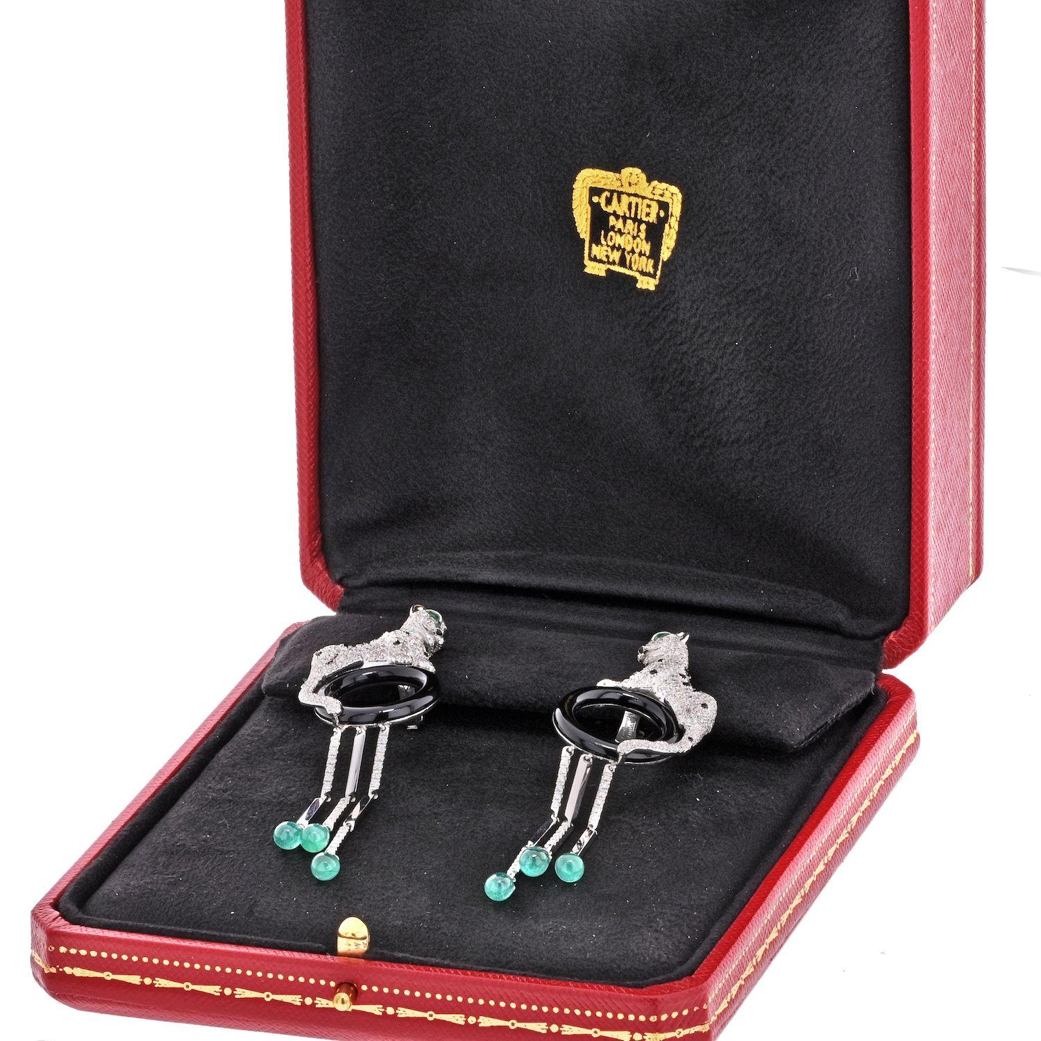 Spectacular Cartier Panthere Diamond Tassel Earrings. Each designed as a panther pavé-set with brilliant-cut diamonds, polished onyx and pear-shaped emerald eyes, upon an onyx hoop supporting three articulated pendants set with brilliant-cut
