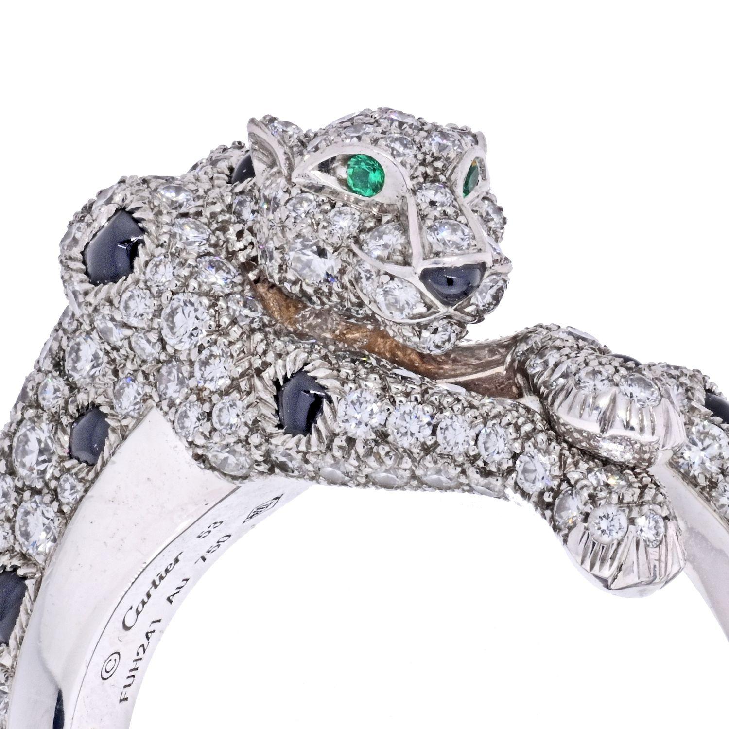 Panthere de Cartier ring in 18K white gold. Detailed with gleaming emeralds for eyes and sparkling diamonds and onyx stones depicting its majestic coat. 264 brilliant-cut diamonds totaling 1.66 carat. Width of the pattern: 8.7 mm. 
Ring size 53,