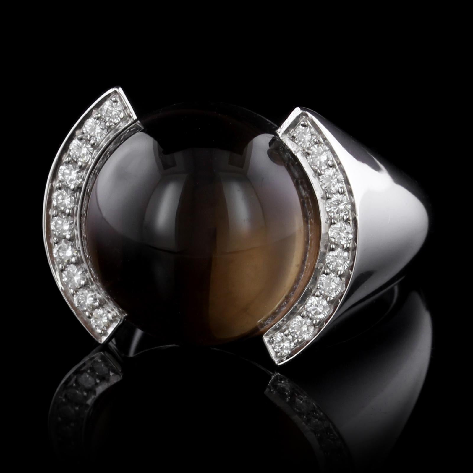 Cartier 18K White Gold Smoky Quartz and Diamond Ring. The ring is set with a
cabochon smoky quartz measuring 16.00mm., further set with 20 full cut diamonds,
approx. total wt. .30cts., #AZ0131, size 59, U.S. 8 3/4, with original box.