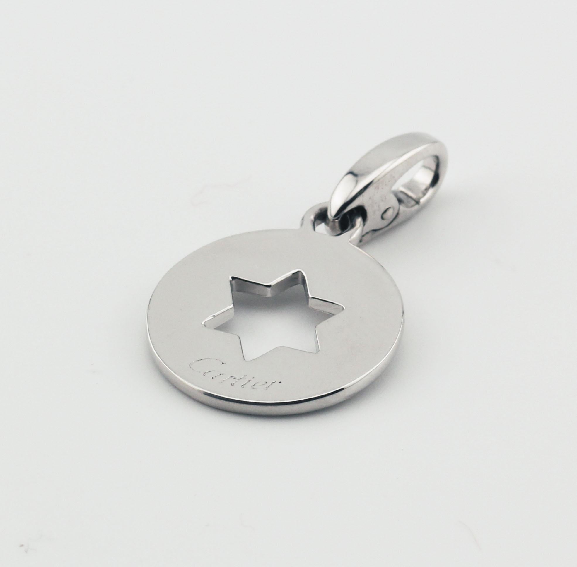 The Cartier 18K White Gold Star of David Charm Pendant is a beautifully crafted piece that combines simplicity with deep cultural significance. This round charm is made from luxurious 18k white gold, exuding a warm, radiant glow that highlights
