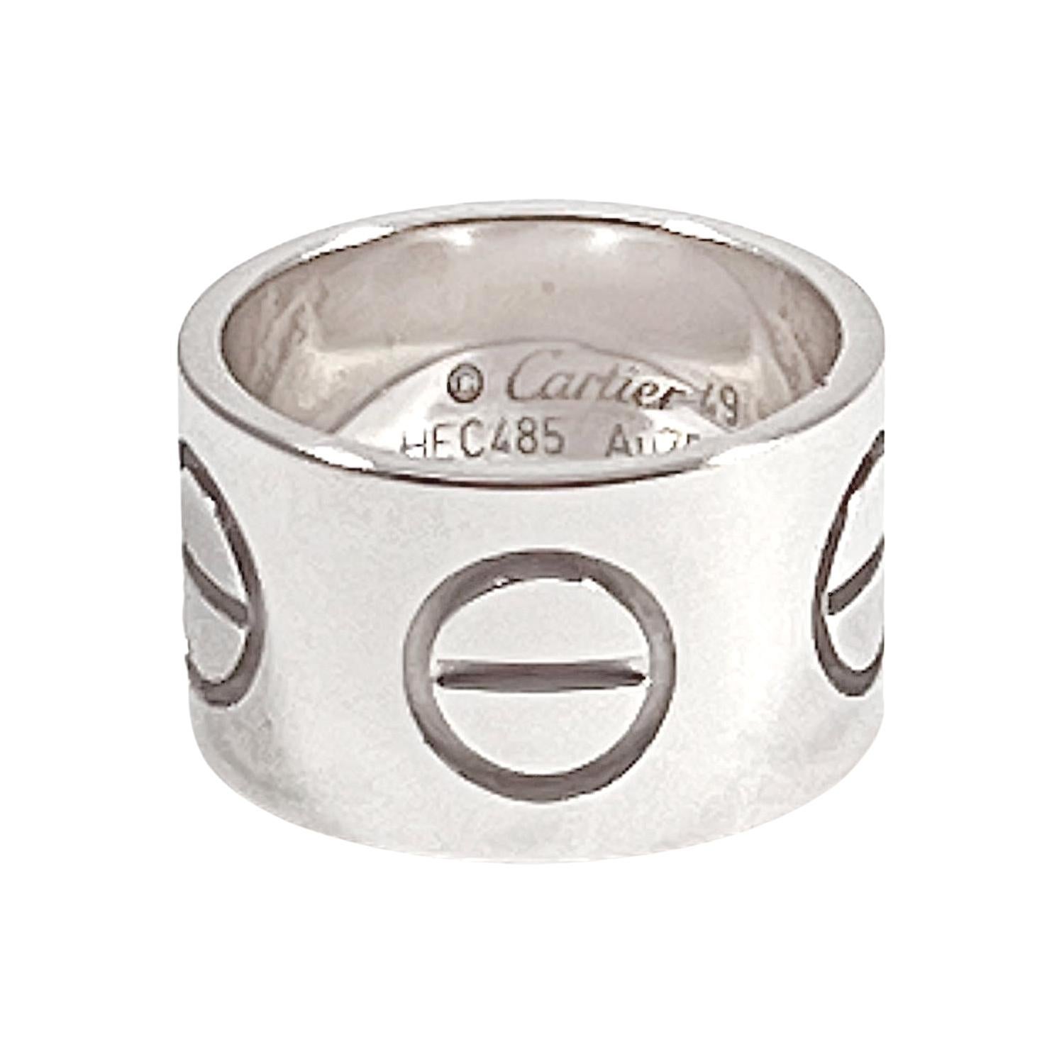 Cartier wide LOVE band ring in polished 18K white gold. Signed '© Cartier 49' serial number and 'AU750' with Cartier French gold mark. 11mm wide. Size 4.75 (European - 49). Includes the original Cartier box inner and outer box, along with the