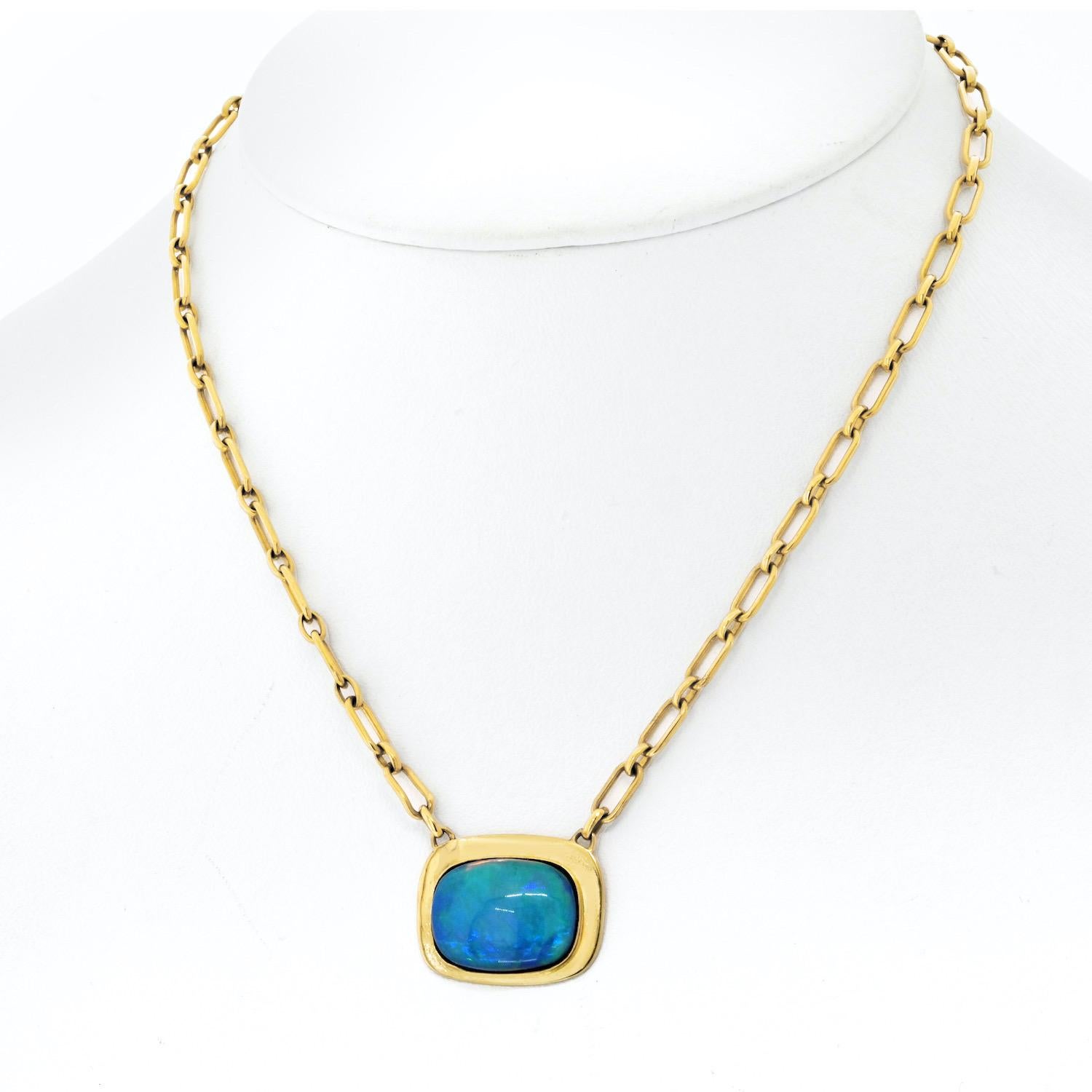 Step back in time with this exquisite vintage Cartier pendant, a true gem from the 1970s. Crafted in 18K yellow gold, this pendant features a captivating fire opal, bezel set to perfection, showcasing its mesmerizing play of colors. The rich, warm