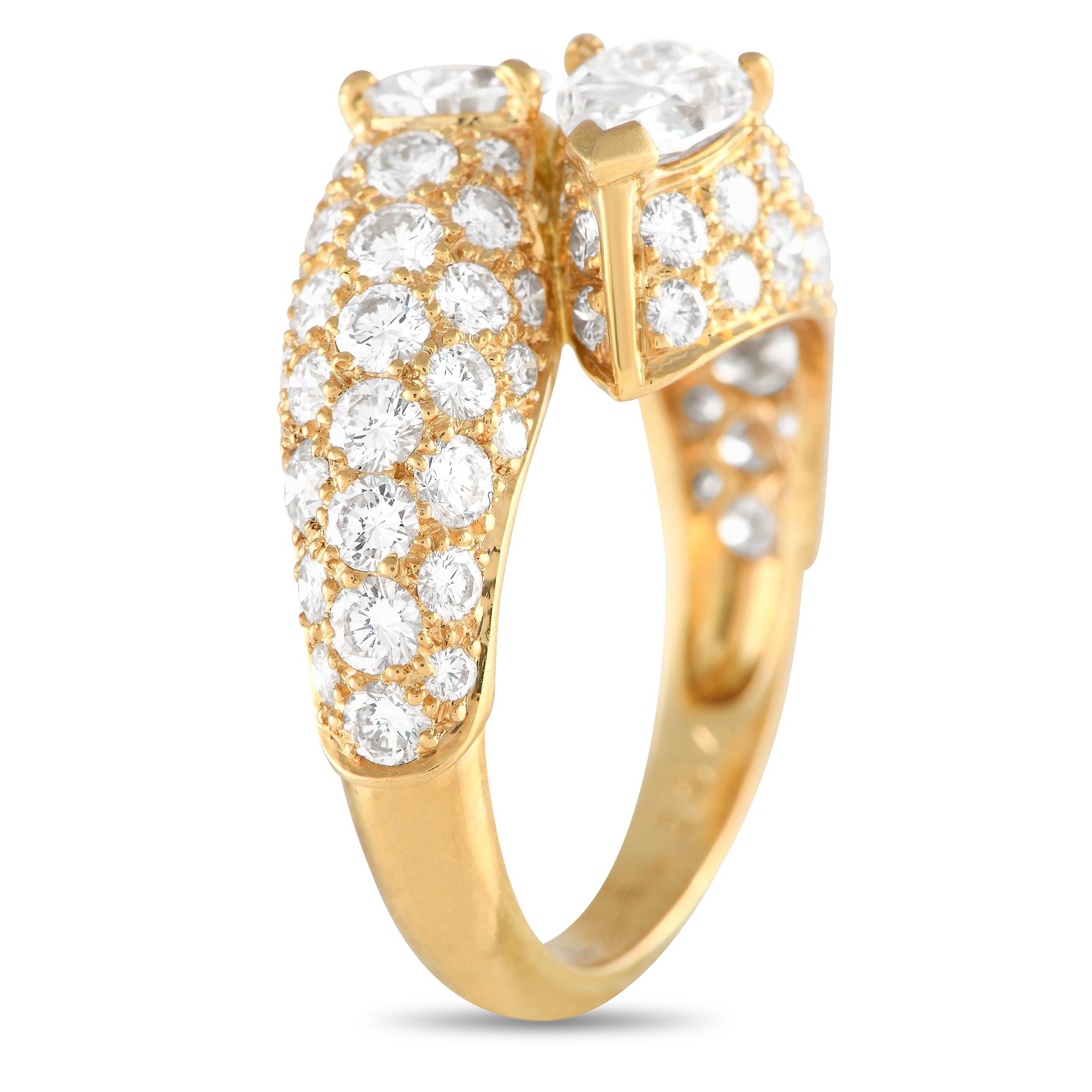 This Cartier ring will effortlessly radiate light. A 0.60 carat pear-shaped diamond and a 0.62 carat pear-shaped diamond with E color and VS1 clarity make a statement at the center of this ring’s elegant 18K Yellow Gold setting. Additional diamonds