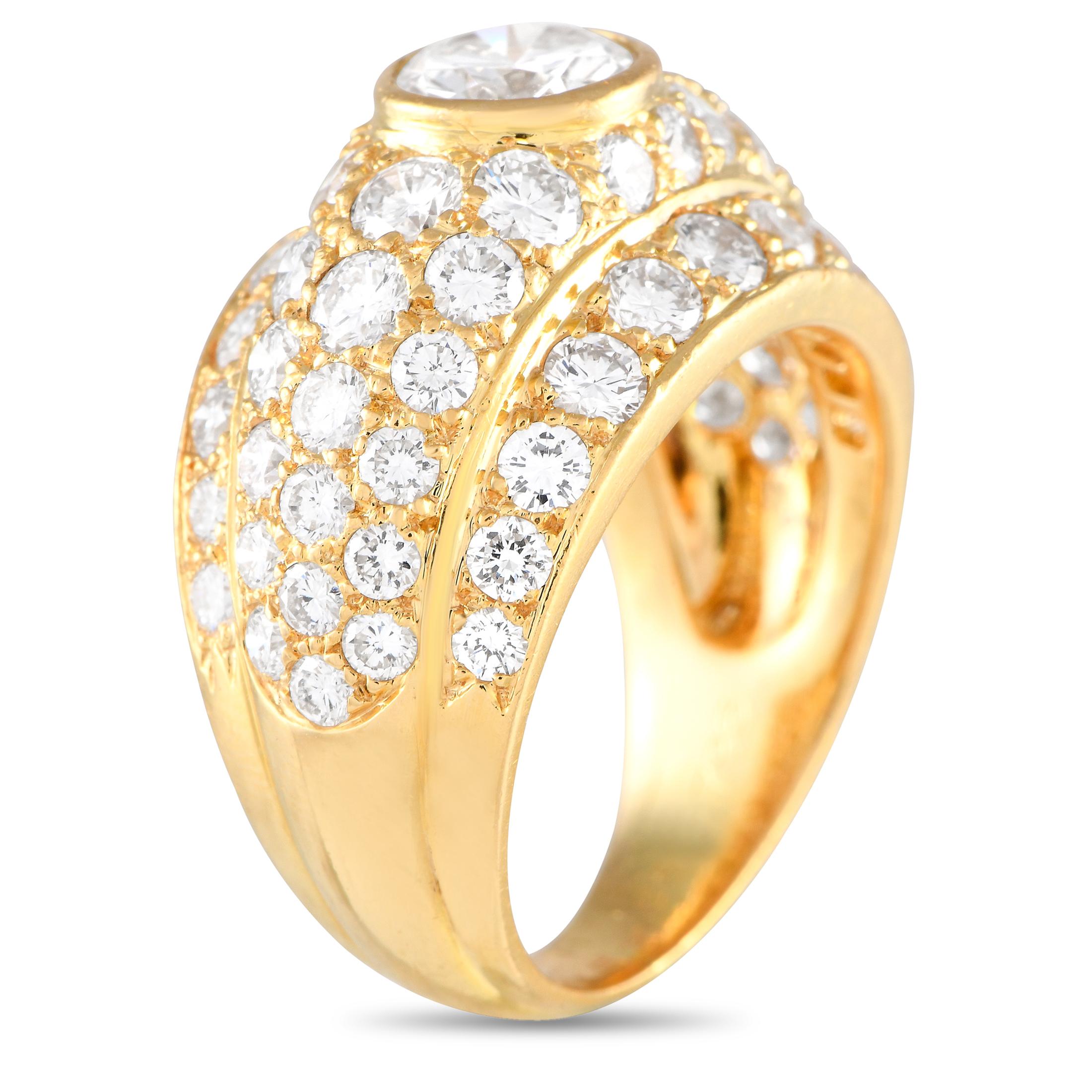 Elegance and refinement define the style of this Cartier dome ring. It features an 18K yellow gold band in high polish finish. The wide top features multiple rows of brilliant round diamonds totaling 4 carats. Taking centerstage is a bezel-set 1.0
