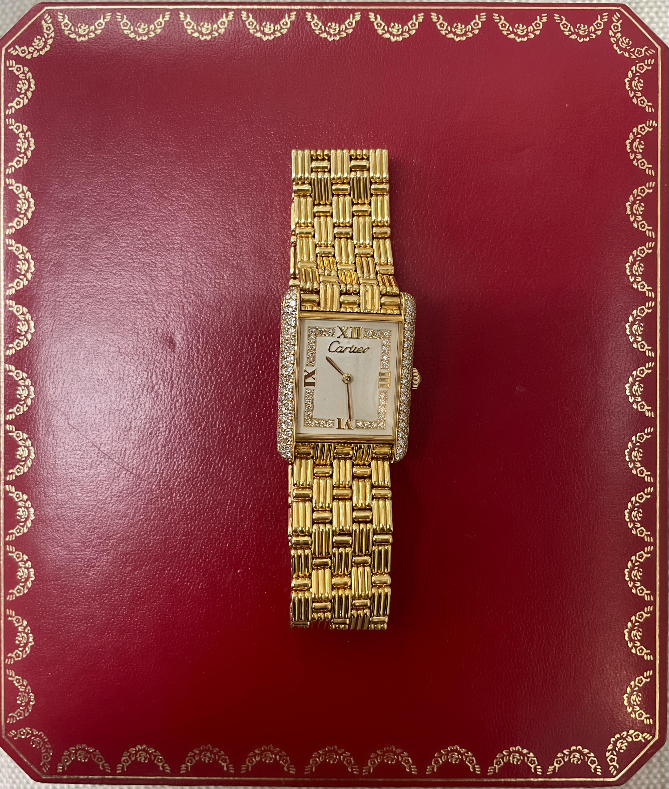 This stylish watch from Cartier's Tank Collection- the Tank Louis, comes with a diamond bezel and diamond dial, 23 x 30 case dimensions inclusive of lugs, quartz movement, fluted mesh link bracelet, deployant clasp, 7 inches inner
