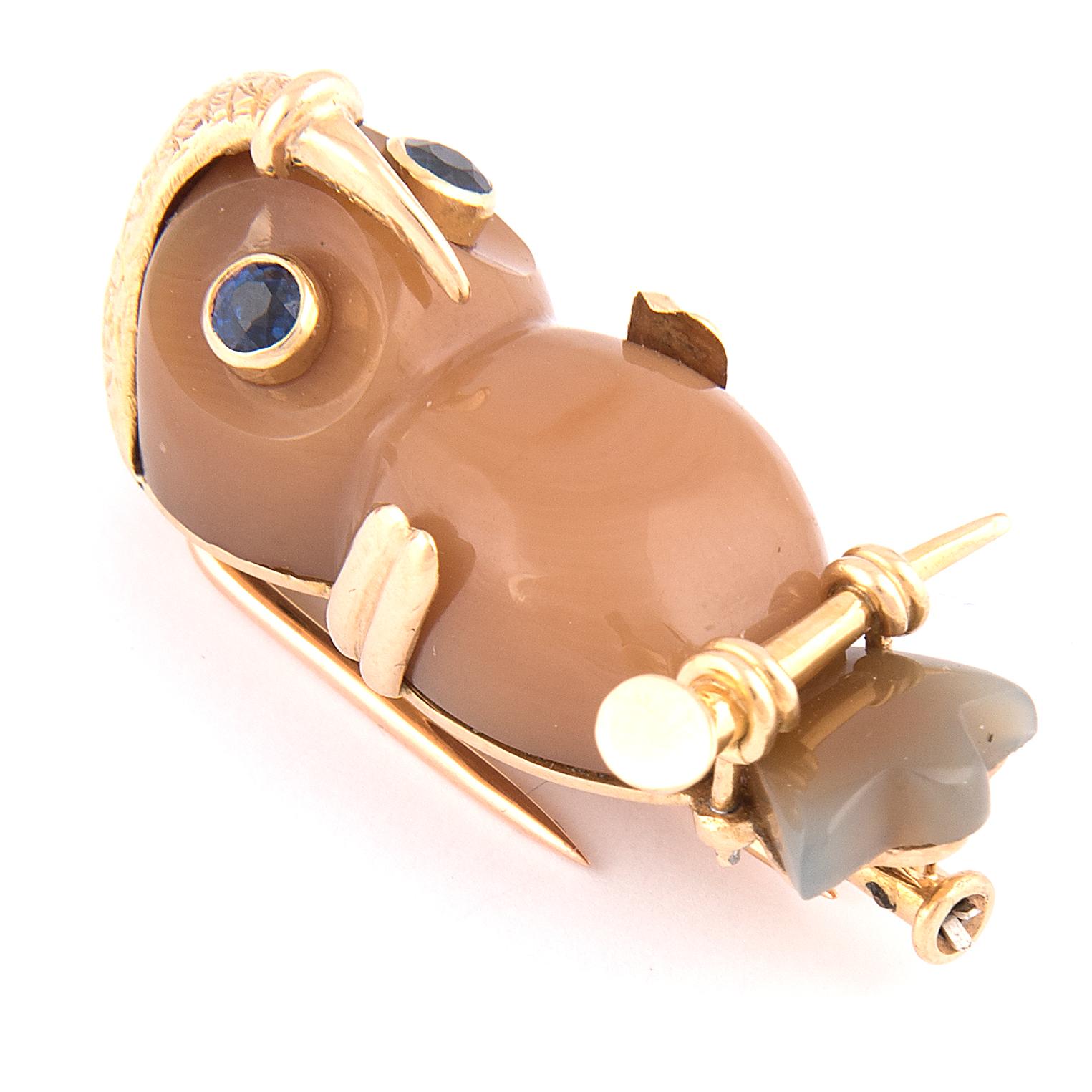 Owl brooch by Cartier Paris, 18k yellow gold, the body in Agate, the eyes in blue sapphire
Signed Cartier France, maker's mark, French hallmarks, marked 18kts and numbered 2853
Circa 1970s
In original box